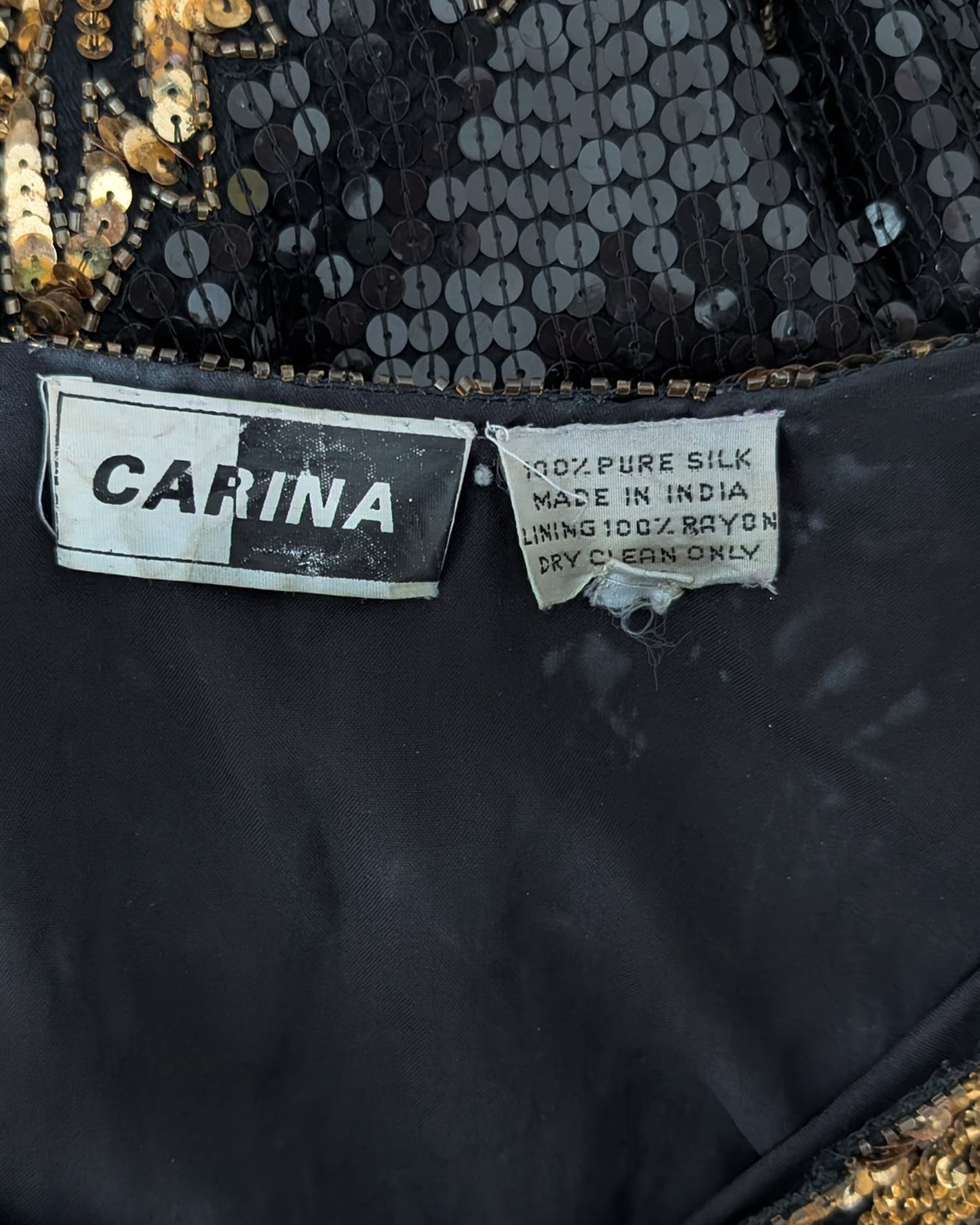 close up of the label which shows the Carina tag, along with some white spots on the lining