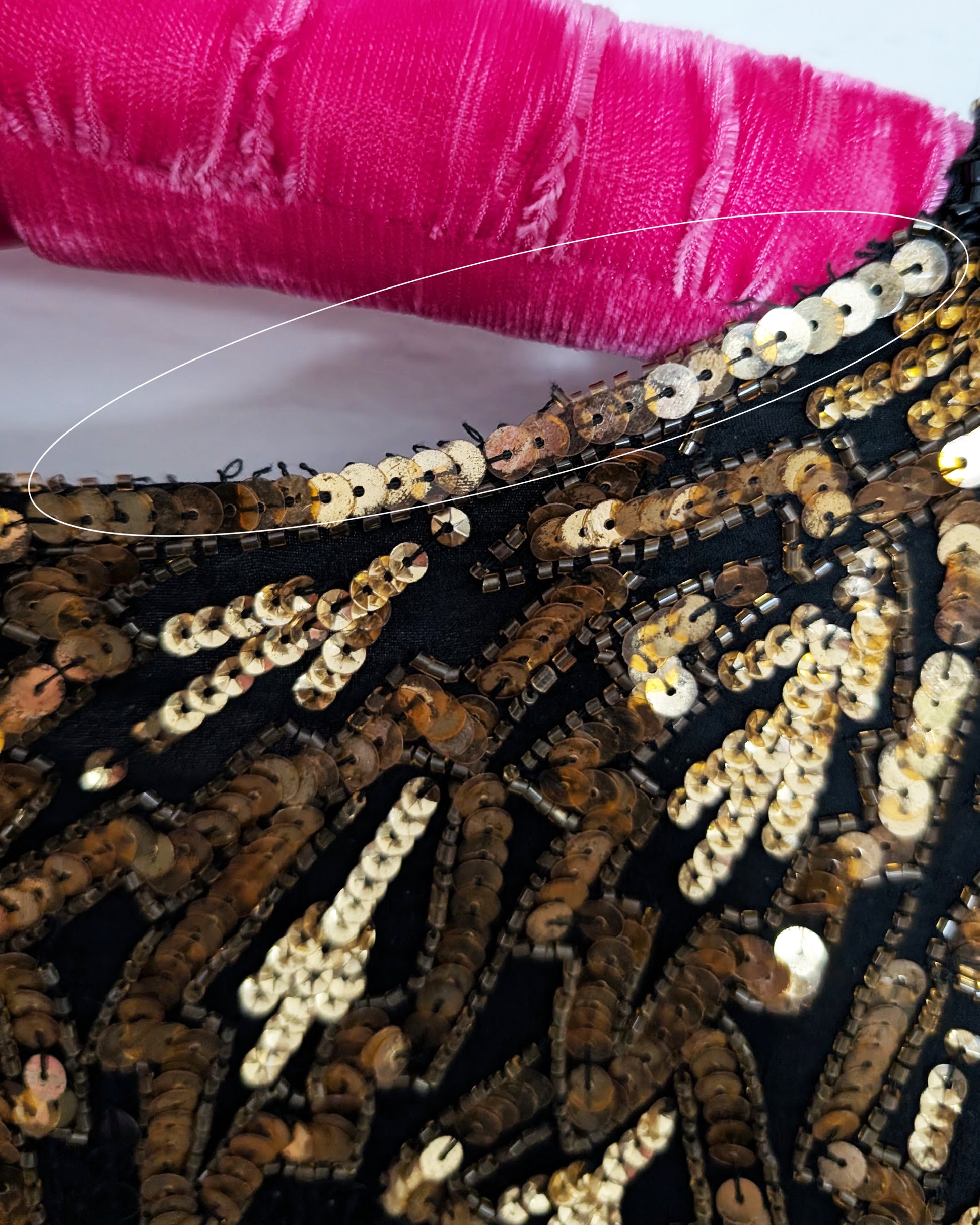 close up of the back of the neckline that is missing some beads