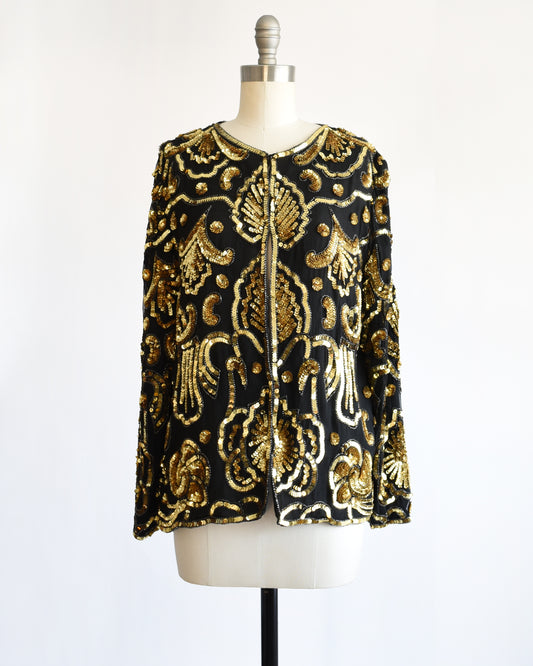 Black and gold vintage sequin  jacket on a mannequin against a white background