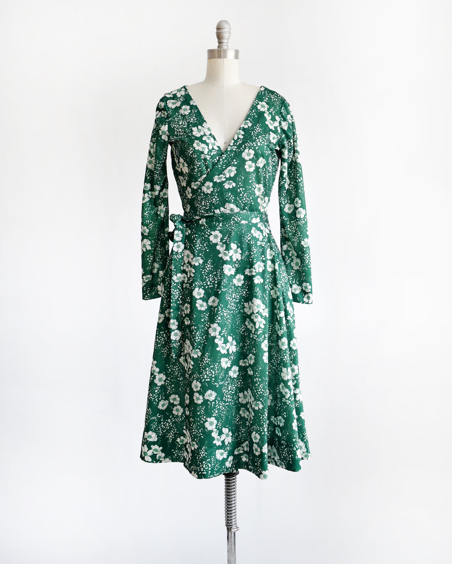 a vintage 70s green and white floral wrap dress