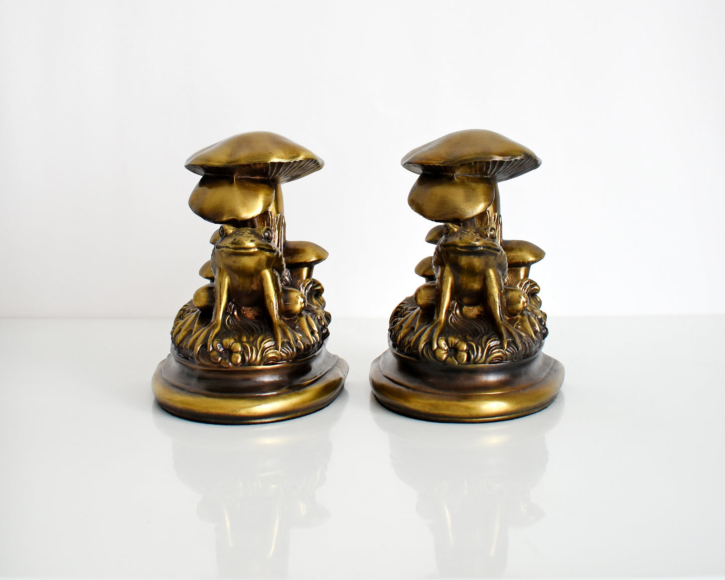 Front view of a vintage brass frog and mushroom bookends
