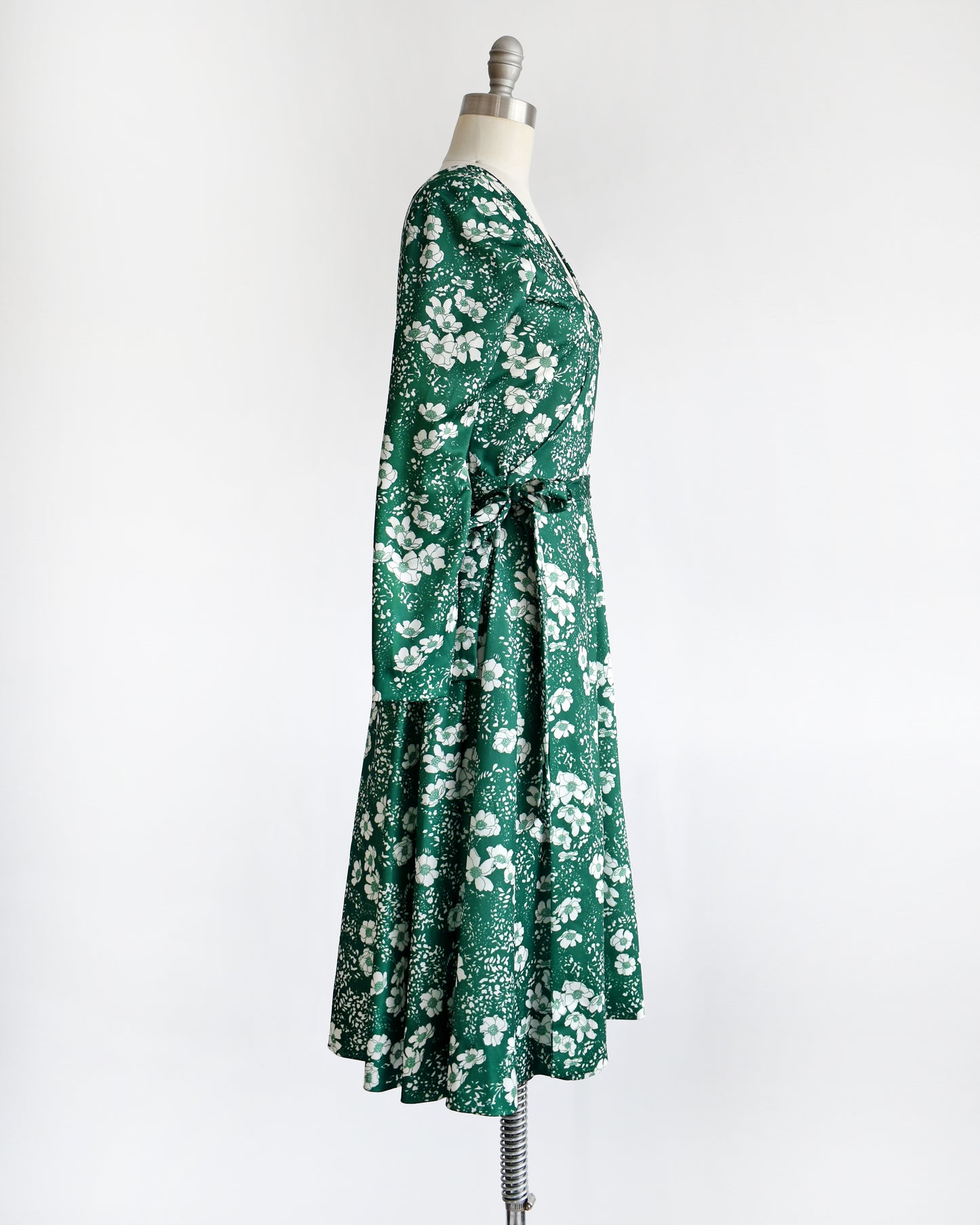 side view of a vintage 70s green and white floral wrap dress