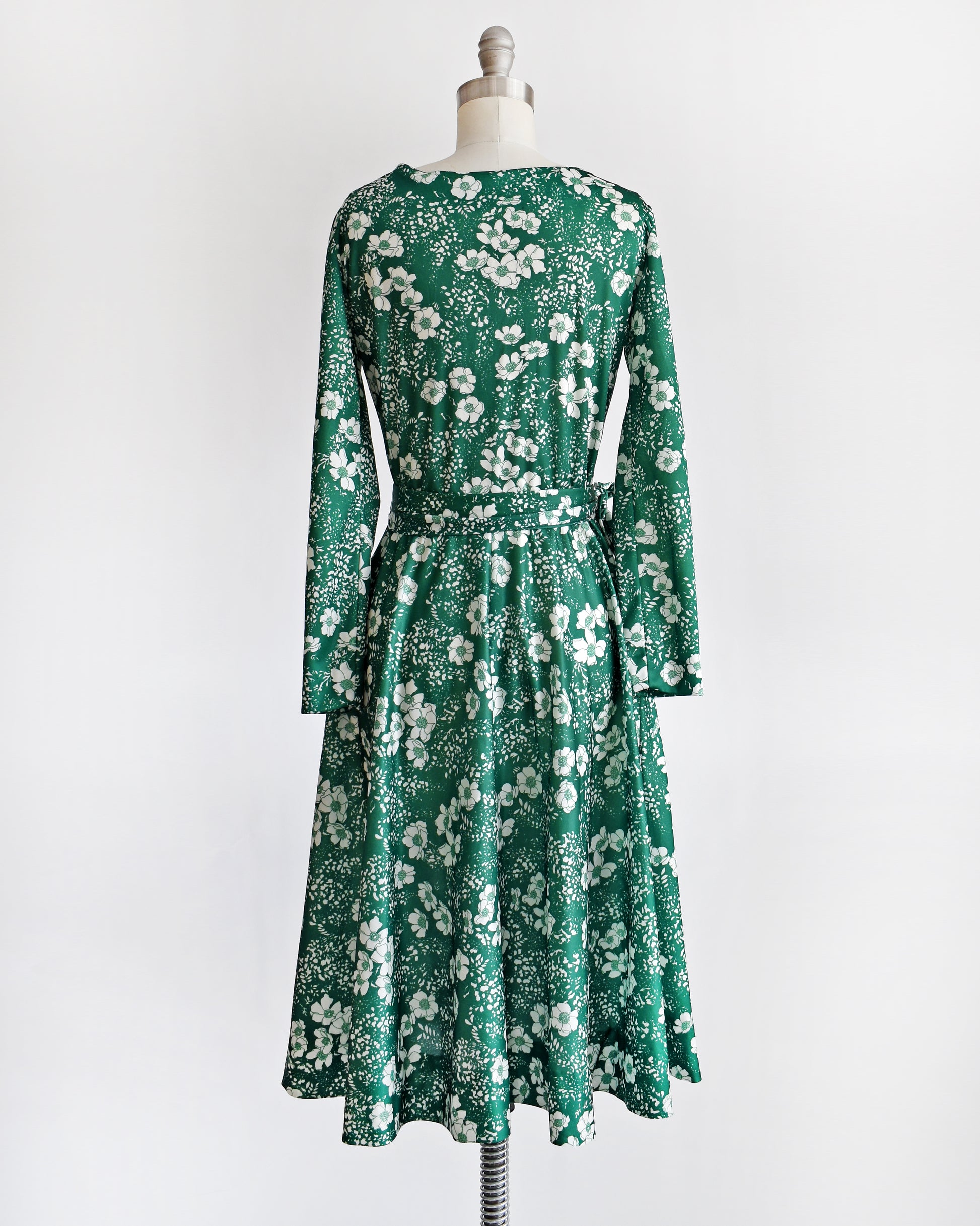 back view of a vintage 70s green and white floral wrap dress