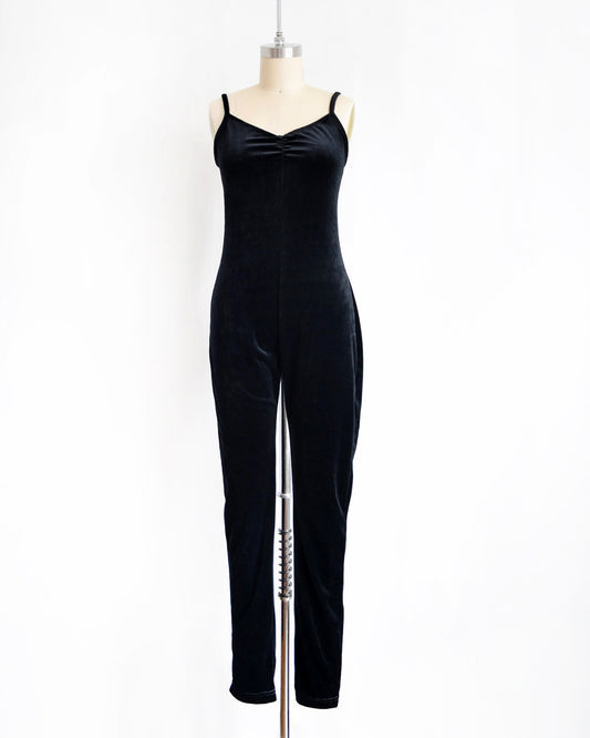 A black velvet jumpsuit displayed on a mannequin against a plain white background.