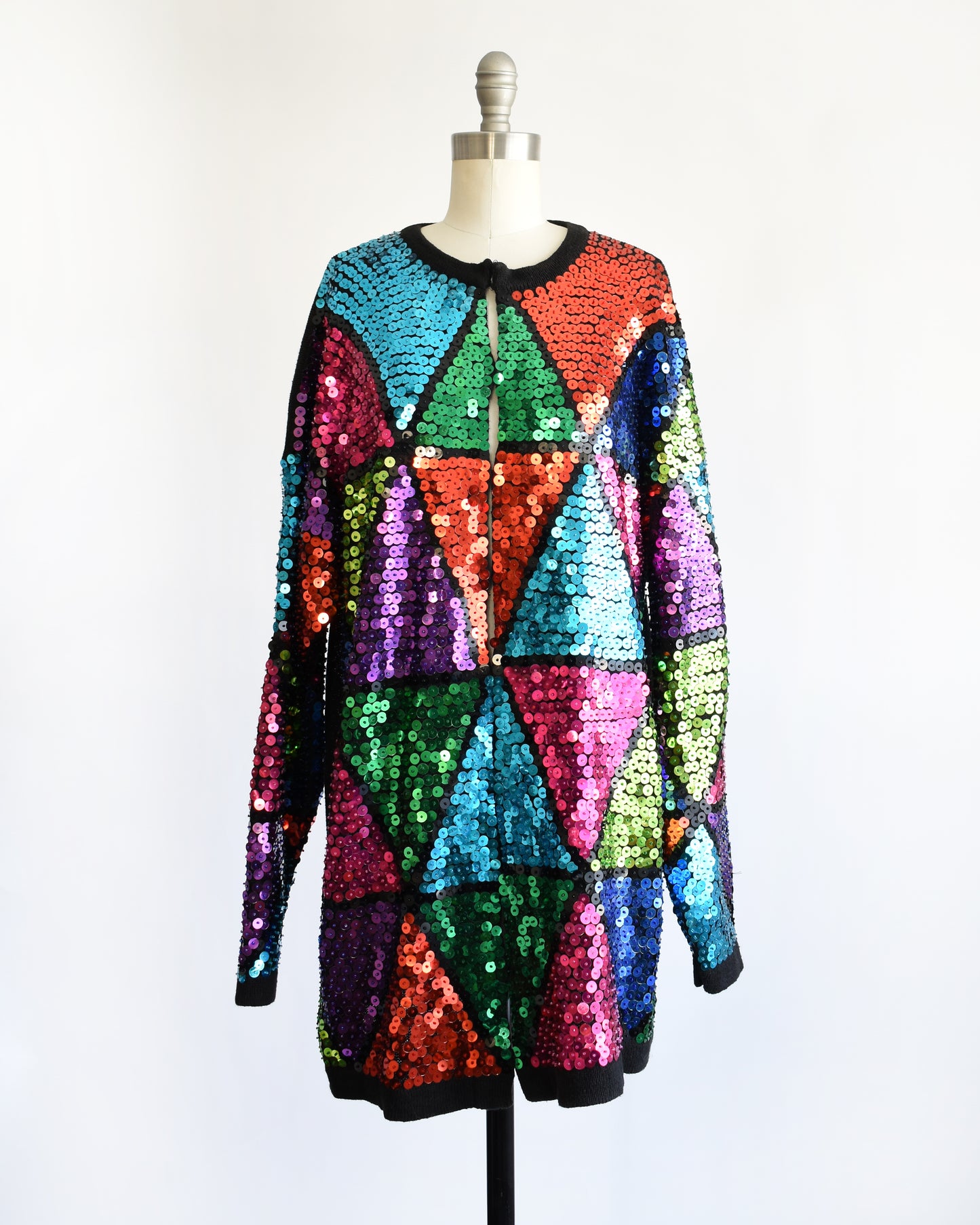 a vintage 80s colorful sequin dress on a mannequin against a white background
