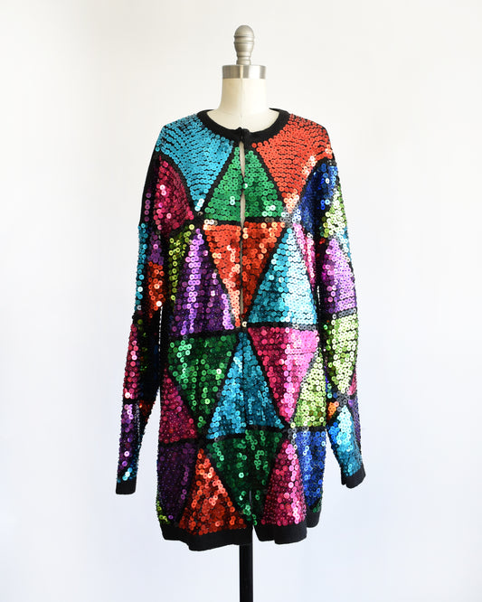 a vintage 80s colorful sequin dress on a mannequin against a white background