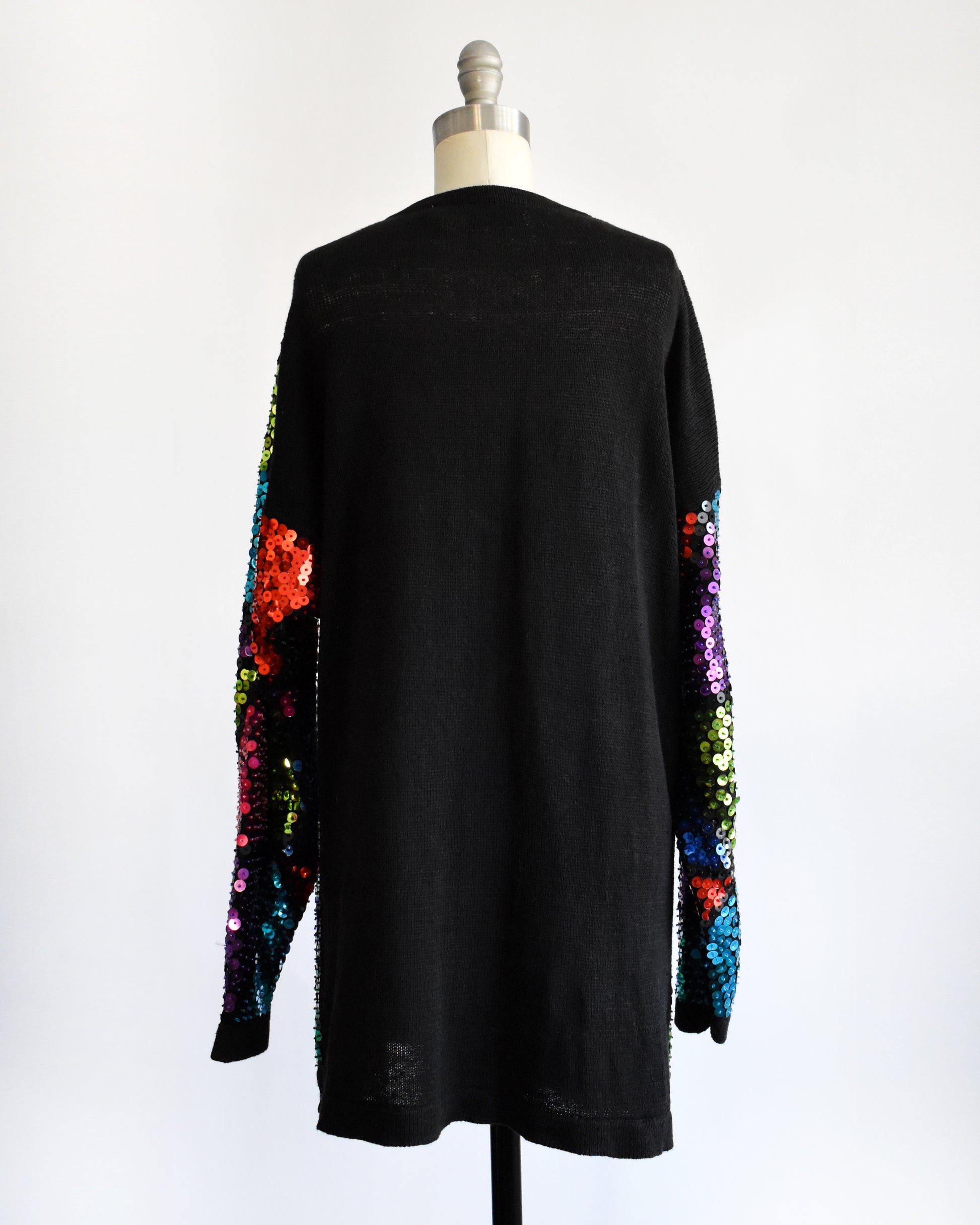 back view of a vintage 80s colorful sequin dress on a mannequin against a white background