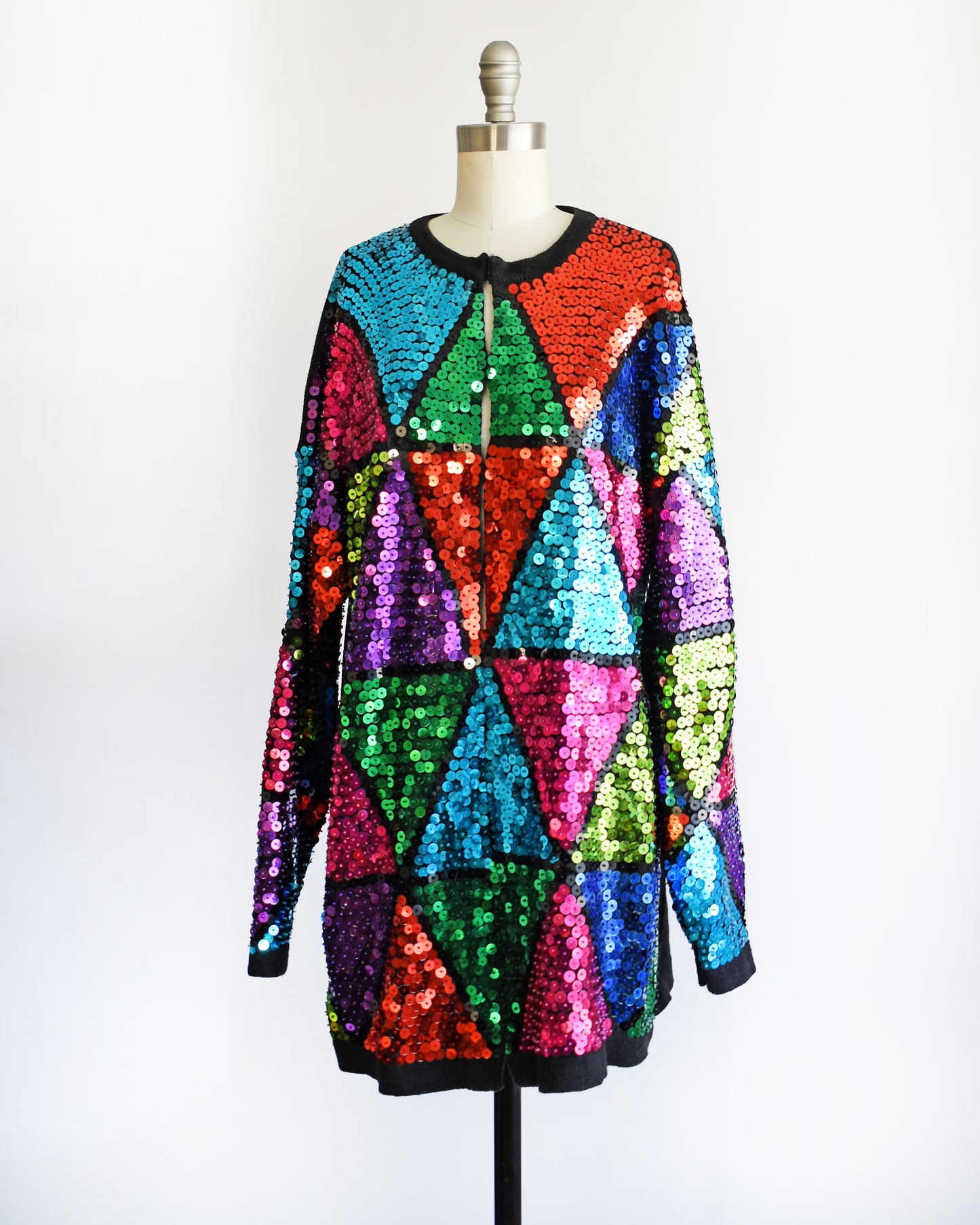 side front view of a vintage 80s colorful sequin dress on a mannequin against a white background