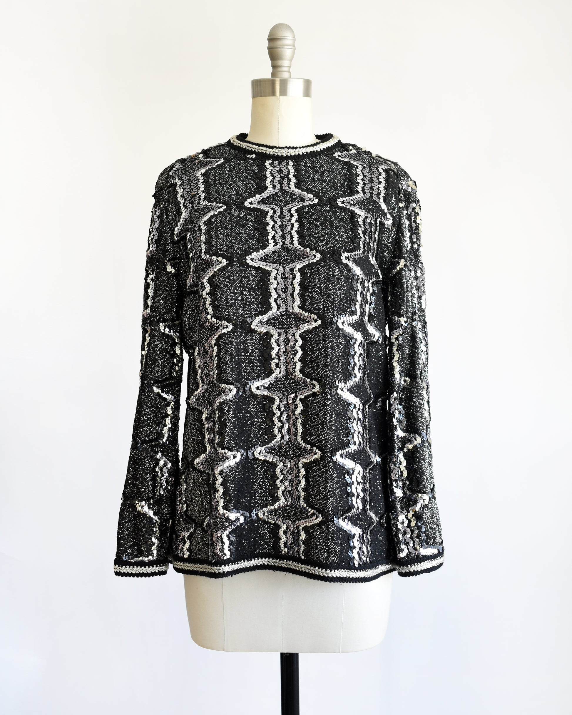 a vintage 1970s/1980s Black and silver sequin top on a mannequin against a white background