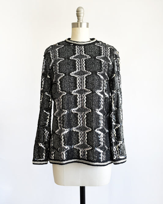a vintage 1970s/1980s Black and silver sequin top on a mannequin against a white background