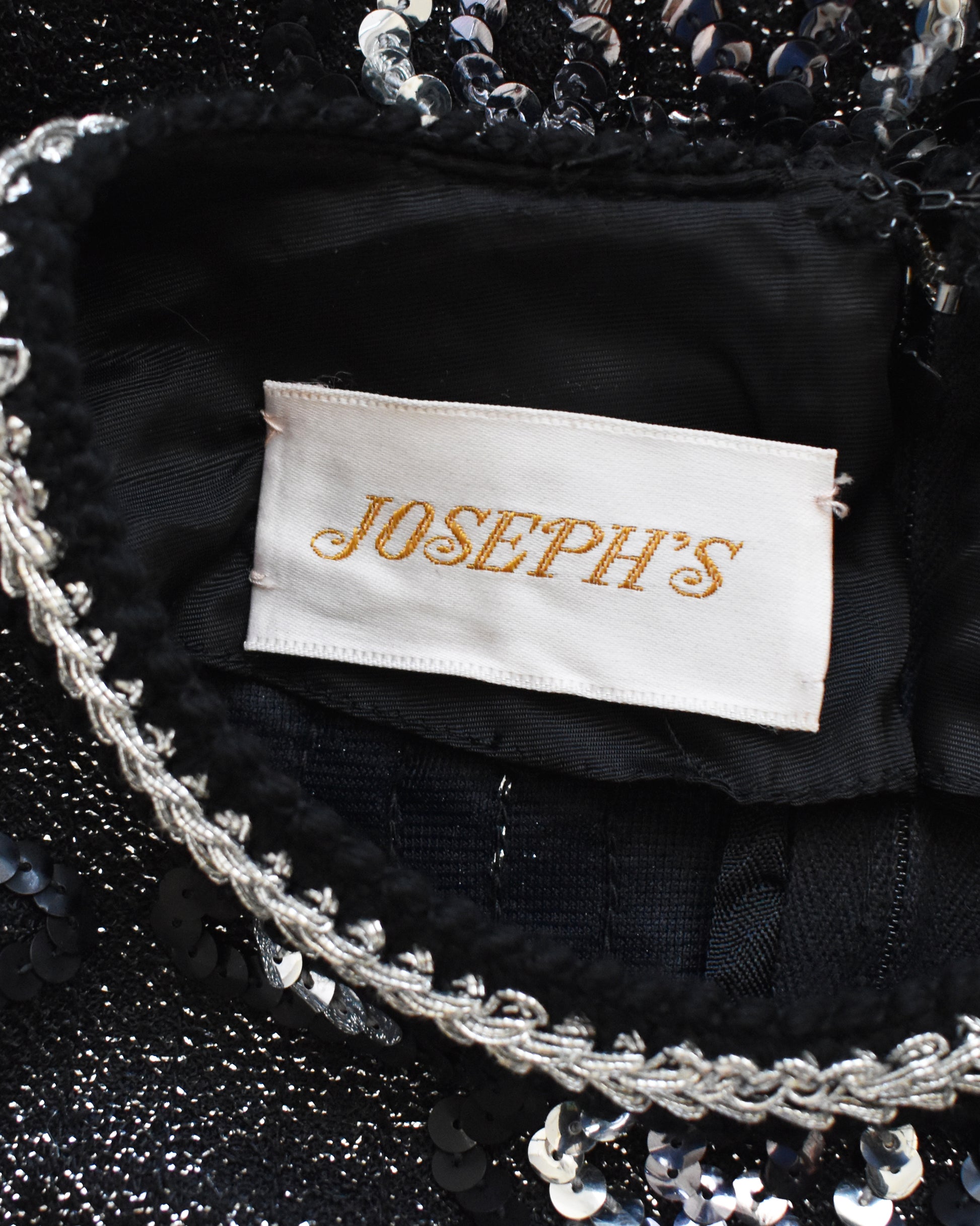 Close-up of a 'JOSEPH'S' label on a black sequined garment.