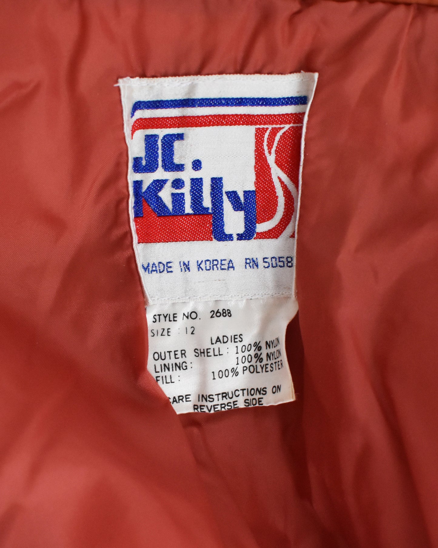 Close-up of a JC Killy label on a orange jacket