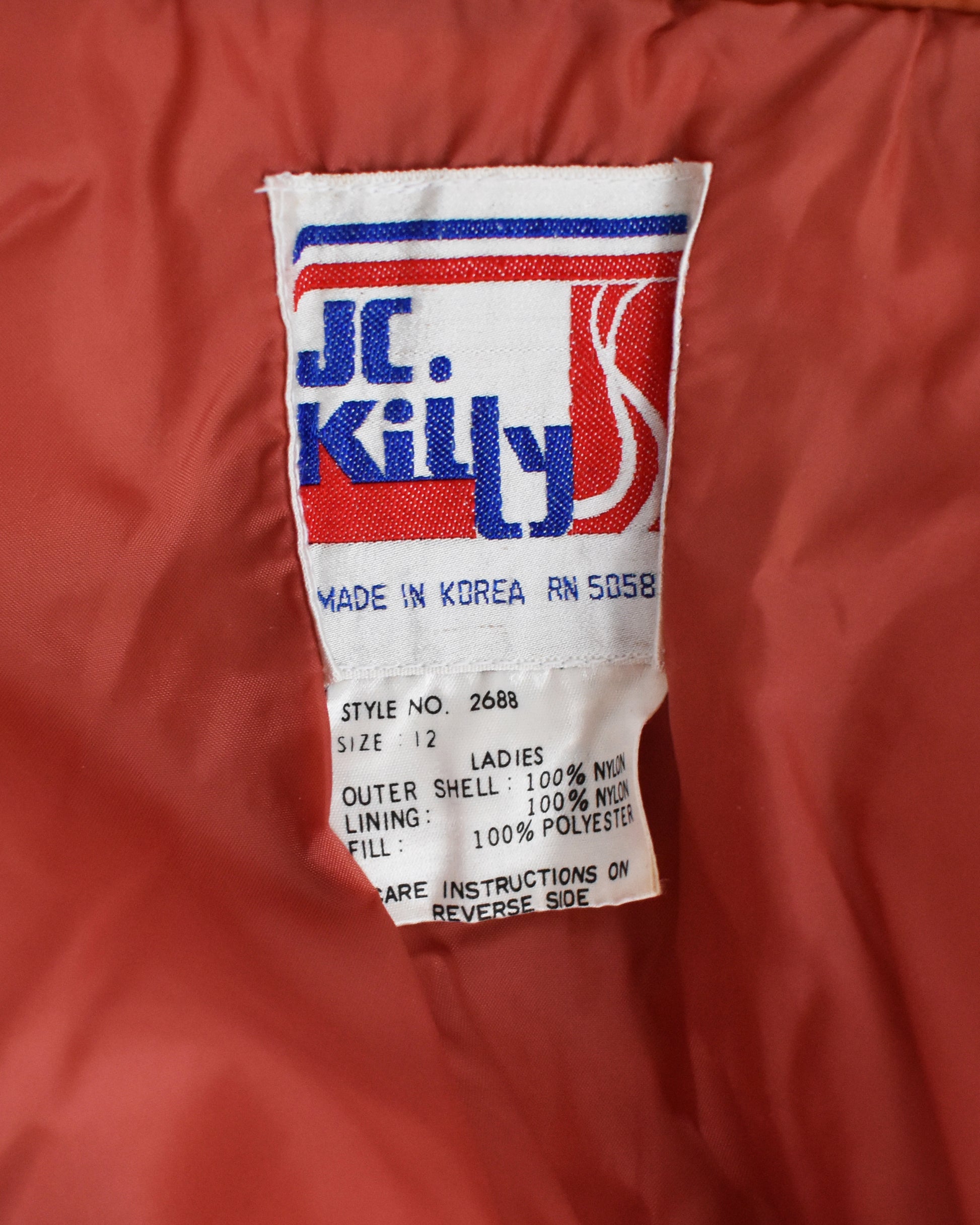 Close-up of a JC Killy label on a orange jacket