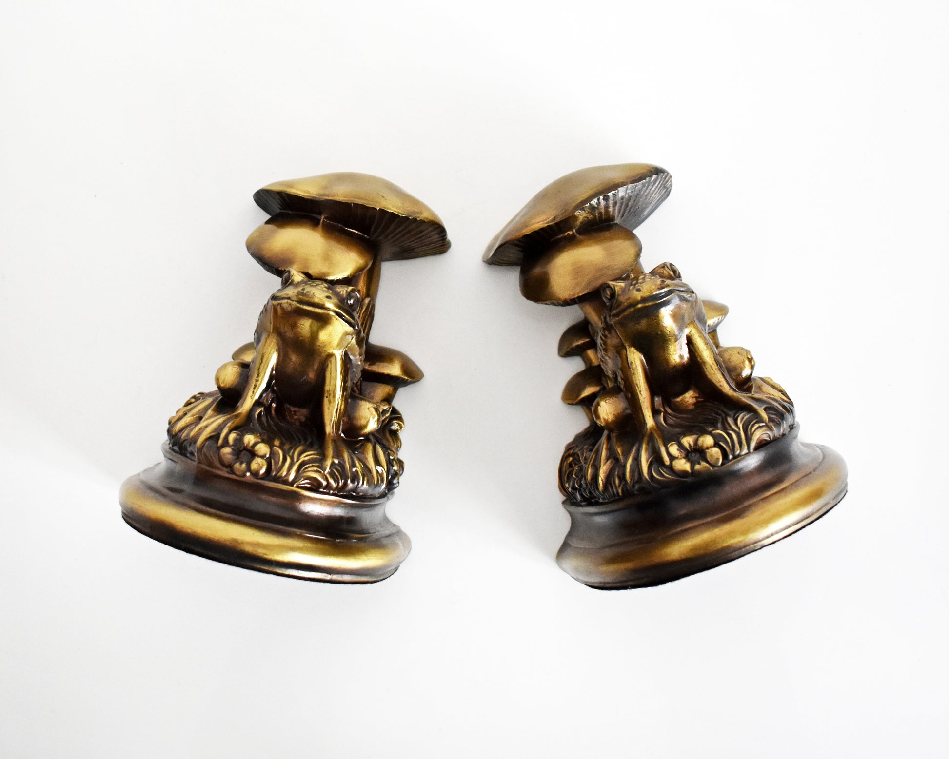 Overhead shot of the front of vintage brass frog and mushroom bookends