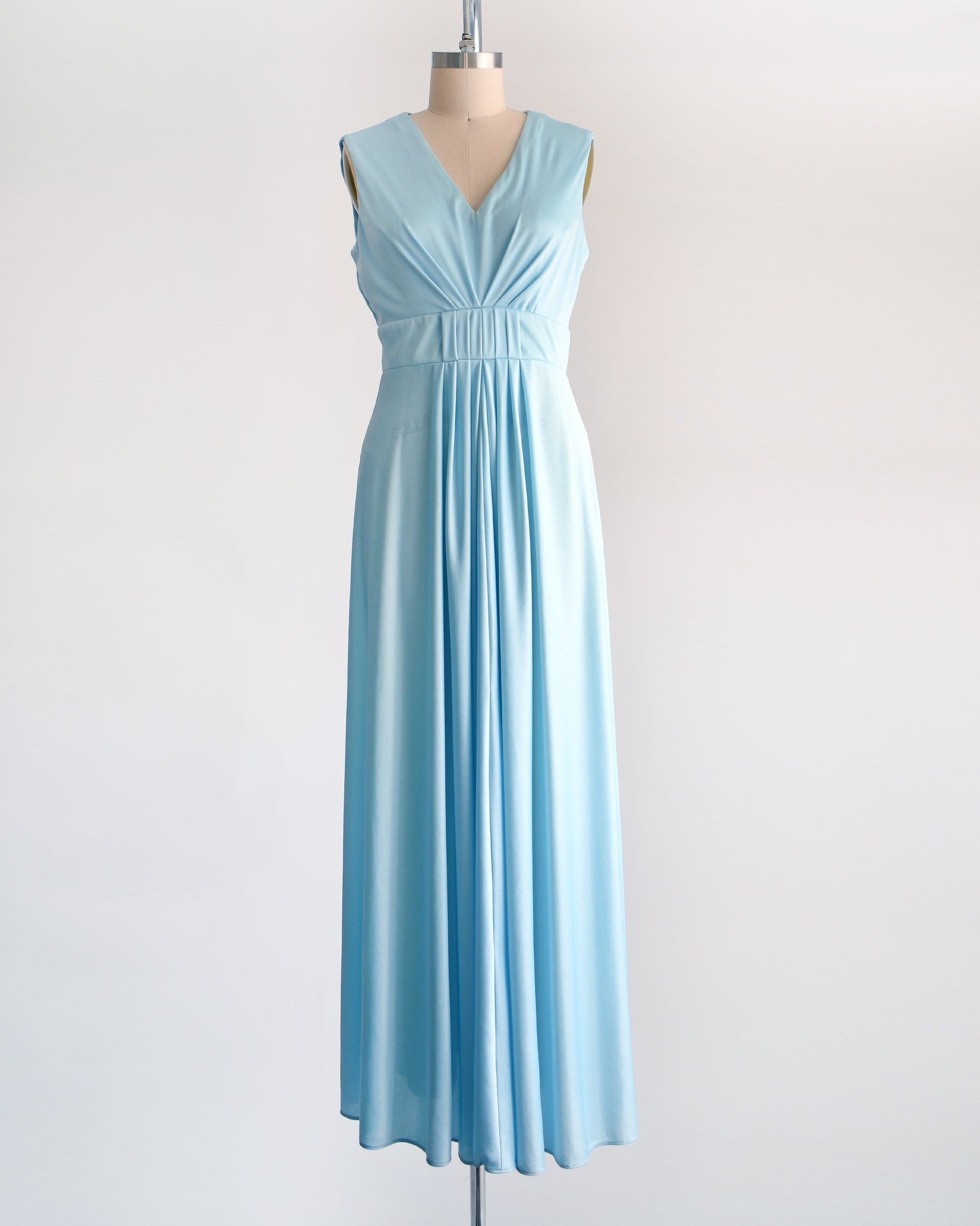 a vintage 70s light blue maxi dress on a dress form