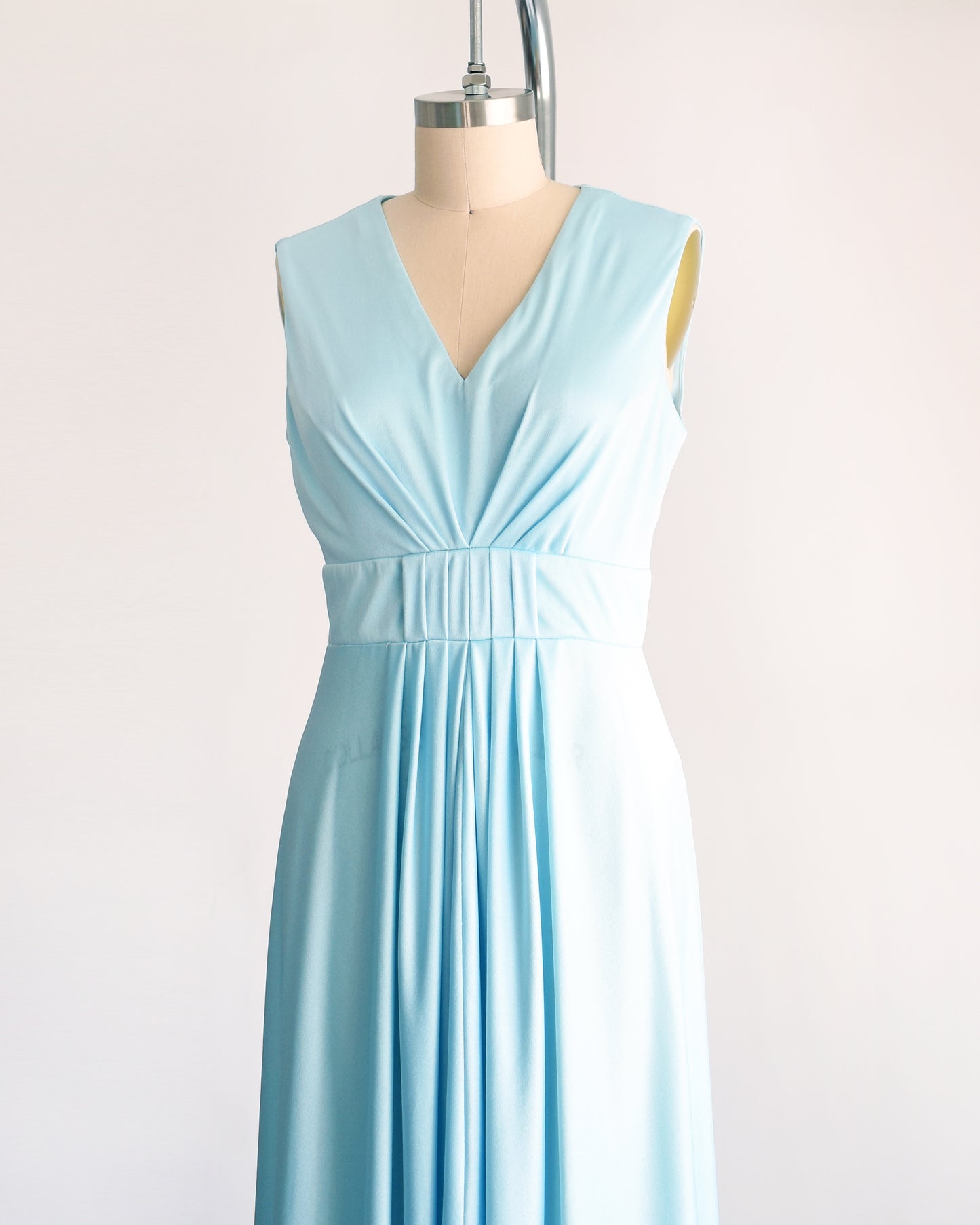 side front view of a vintage 70s light blue maxi dress on a dress form