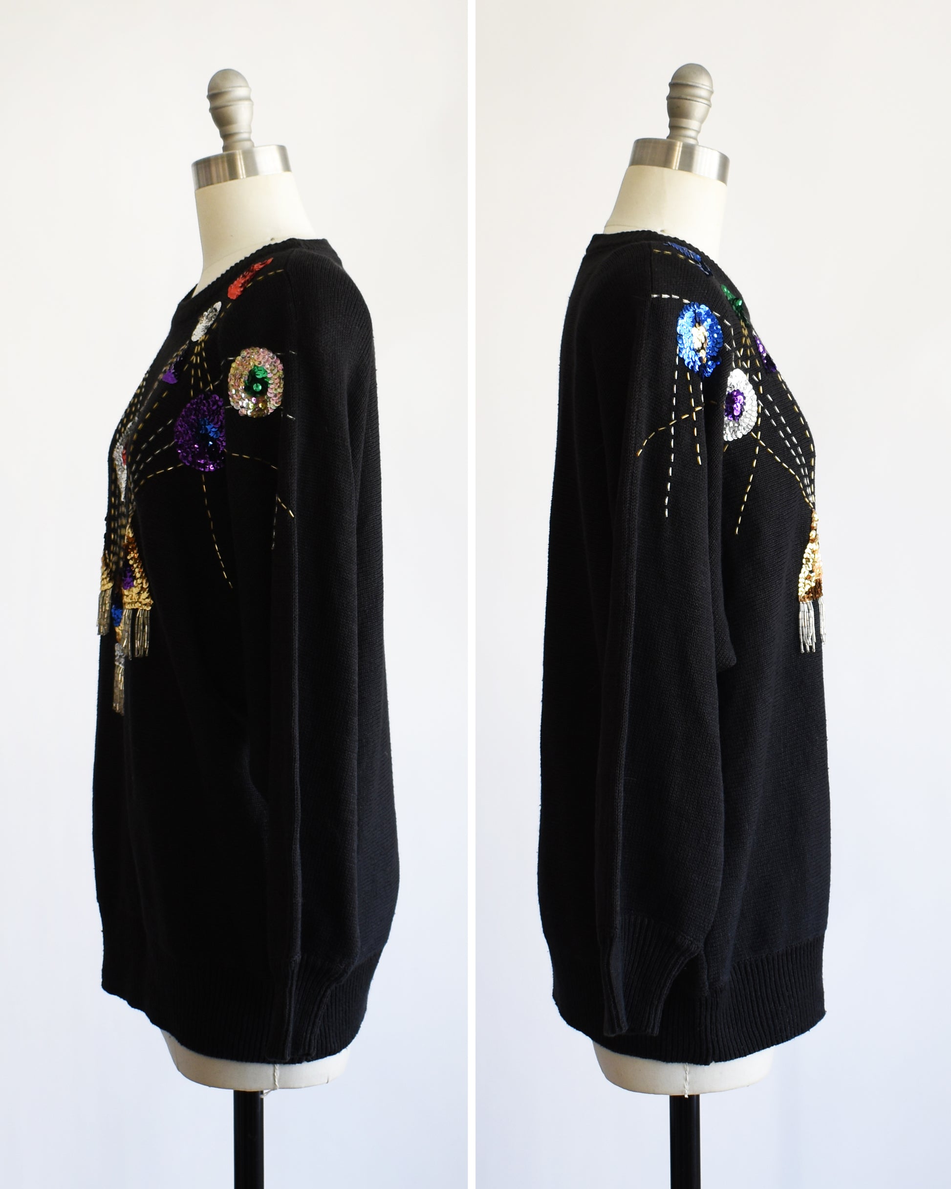 side by side front view of a vintage black sweater with colorful gemstone sequins and tassel details on a mannequin against a white background