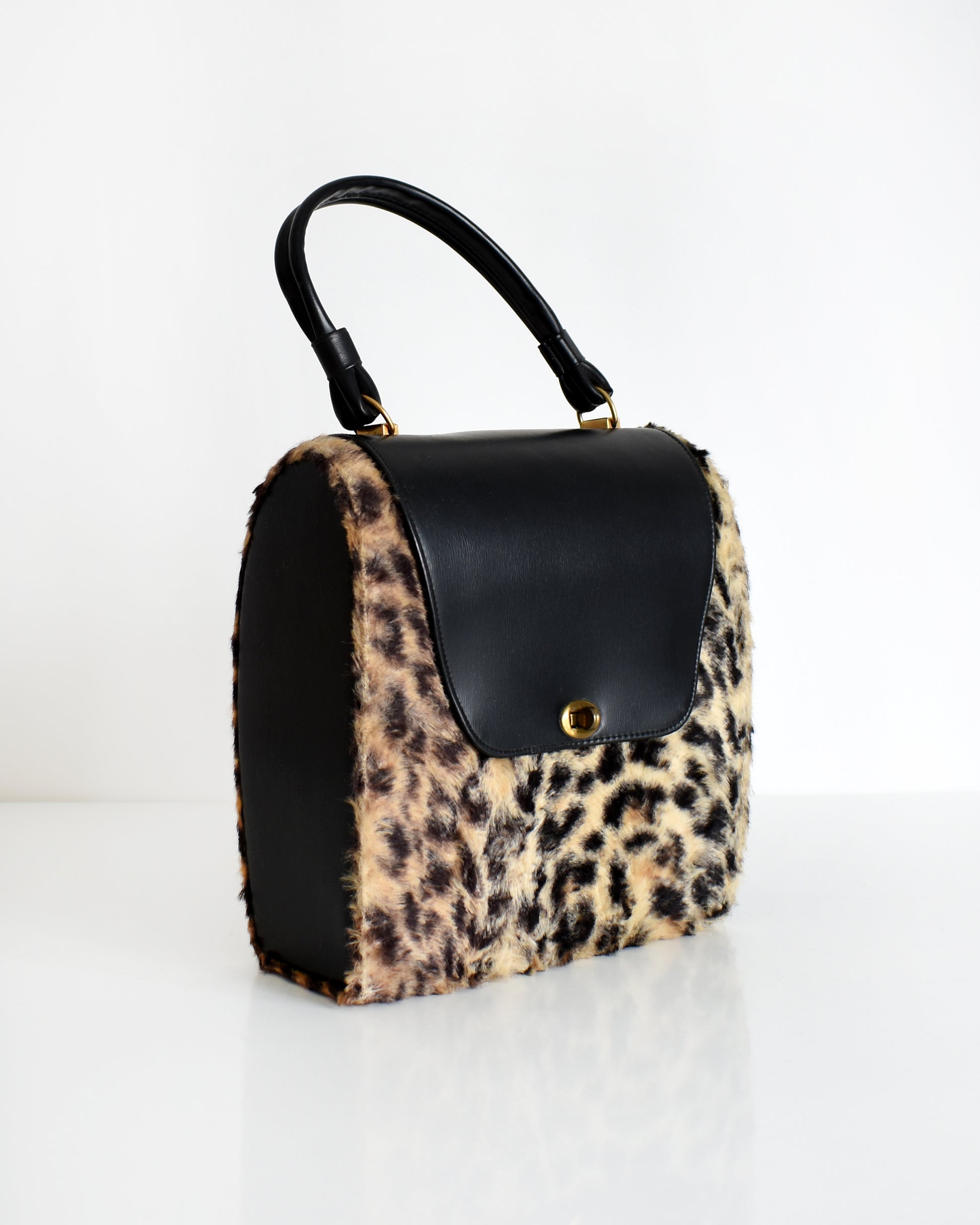 side front view of a vintage 1950s faux leopard print purse 