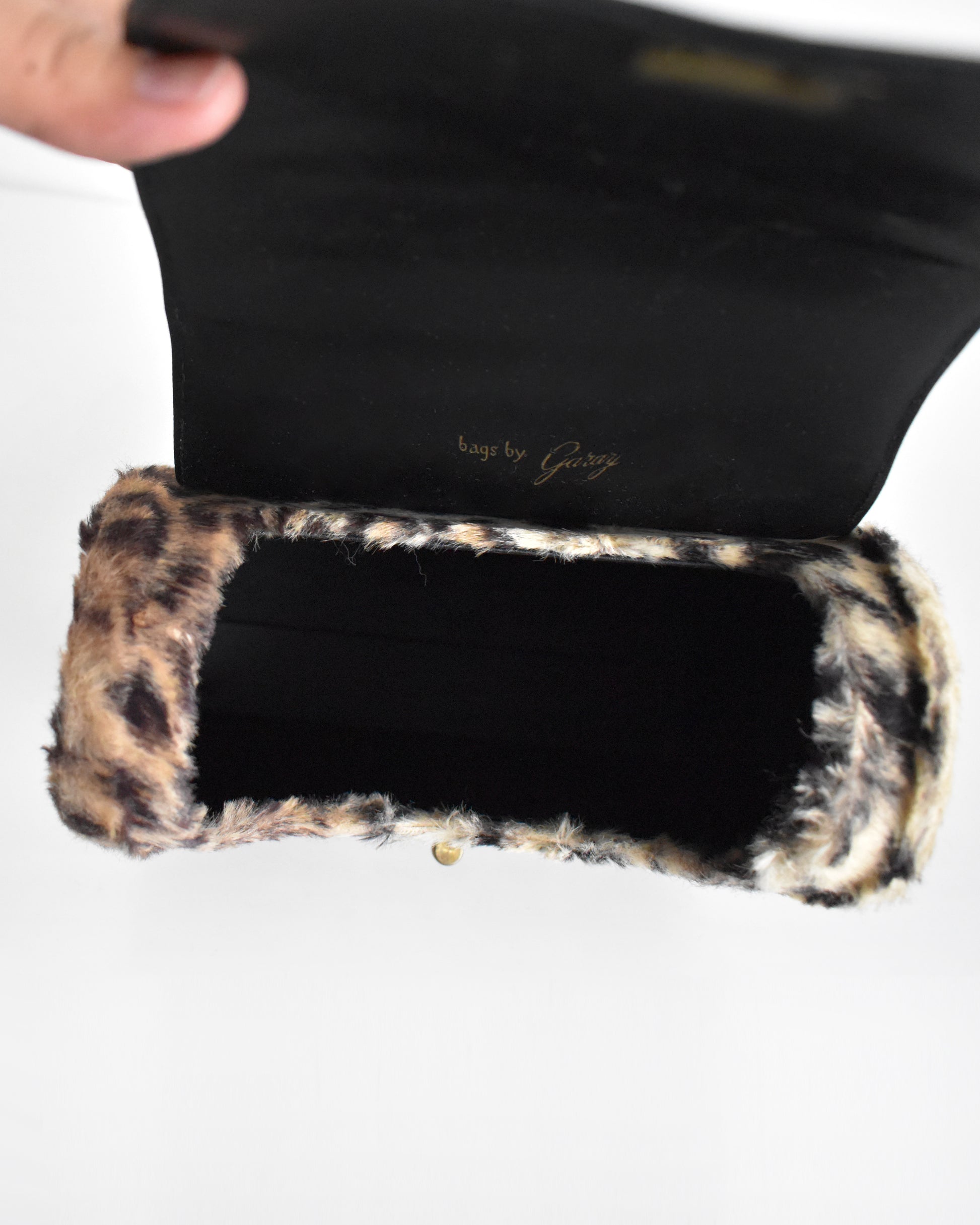 inside of a vintage 1950s faux leopard print purse 