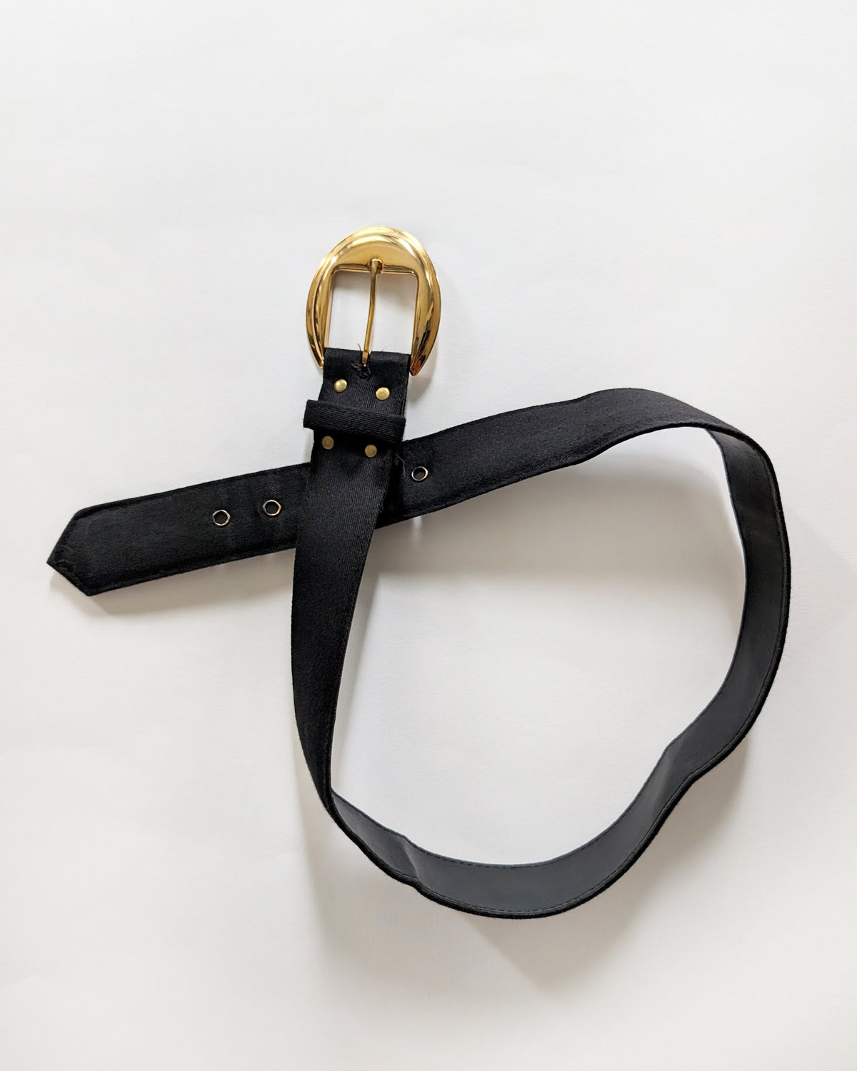 the matching belt that has a gold-tone metal buckle, laid out in a loop on a clean white background.