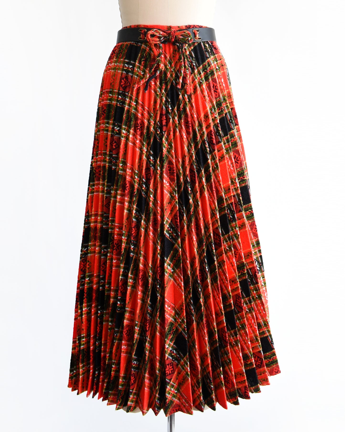 a vintage 1970s red plaid skirt on a mannequin against a white background