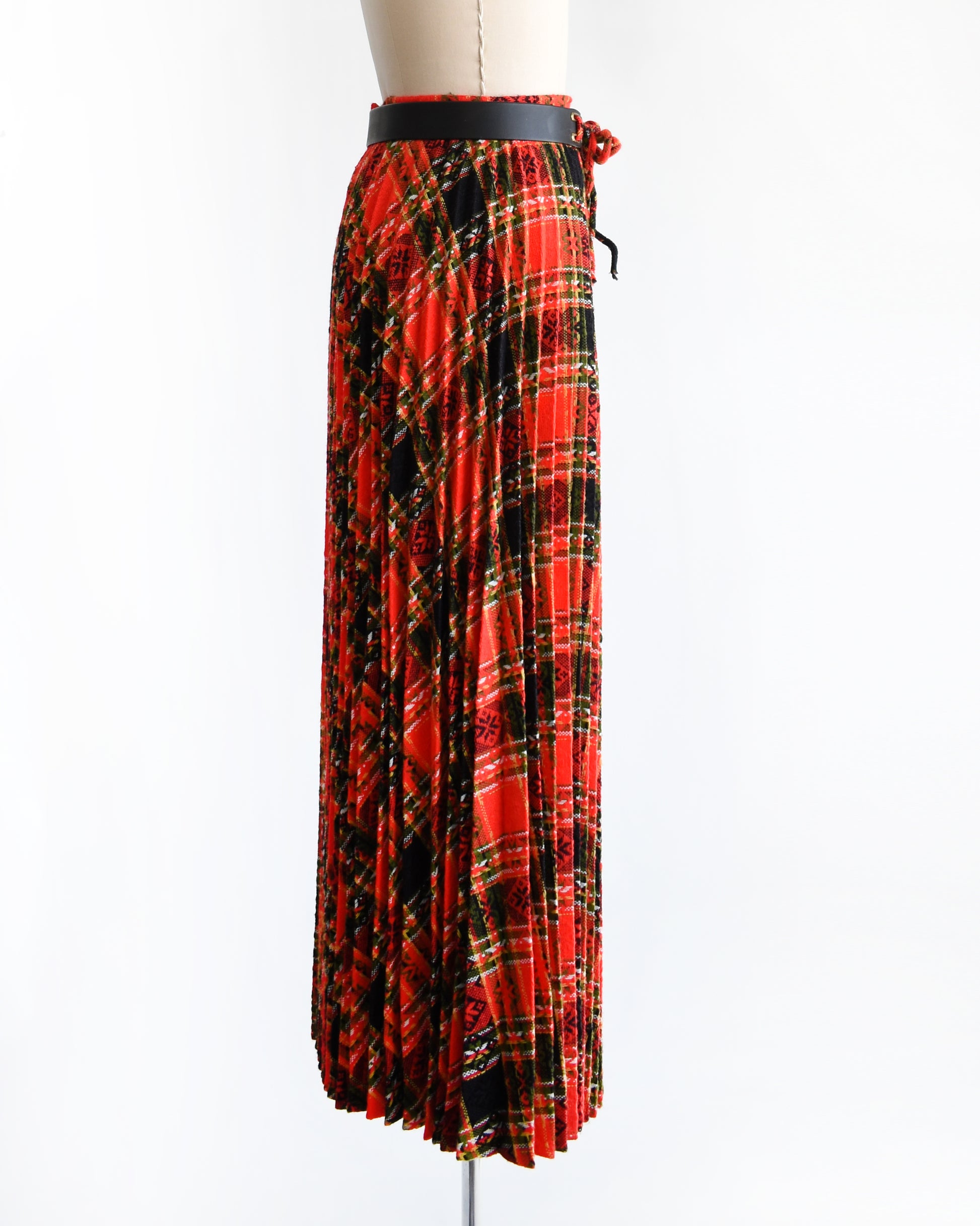 side view of a vintage 1970s red plaid skirt on a mannequin against a white background