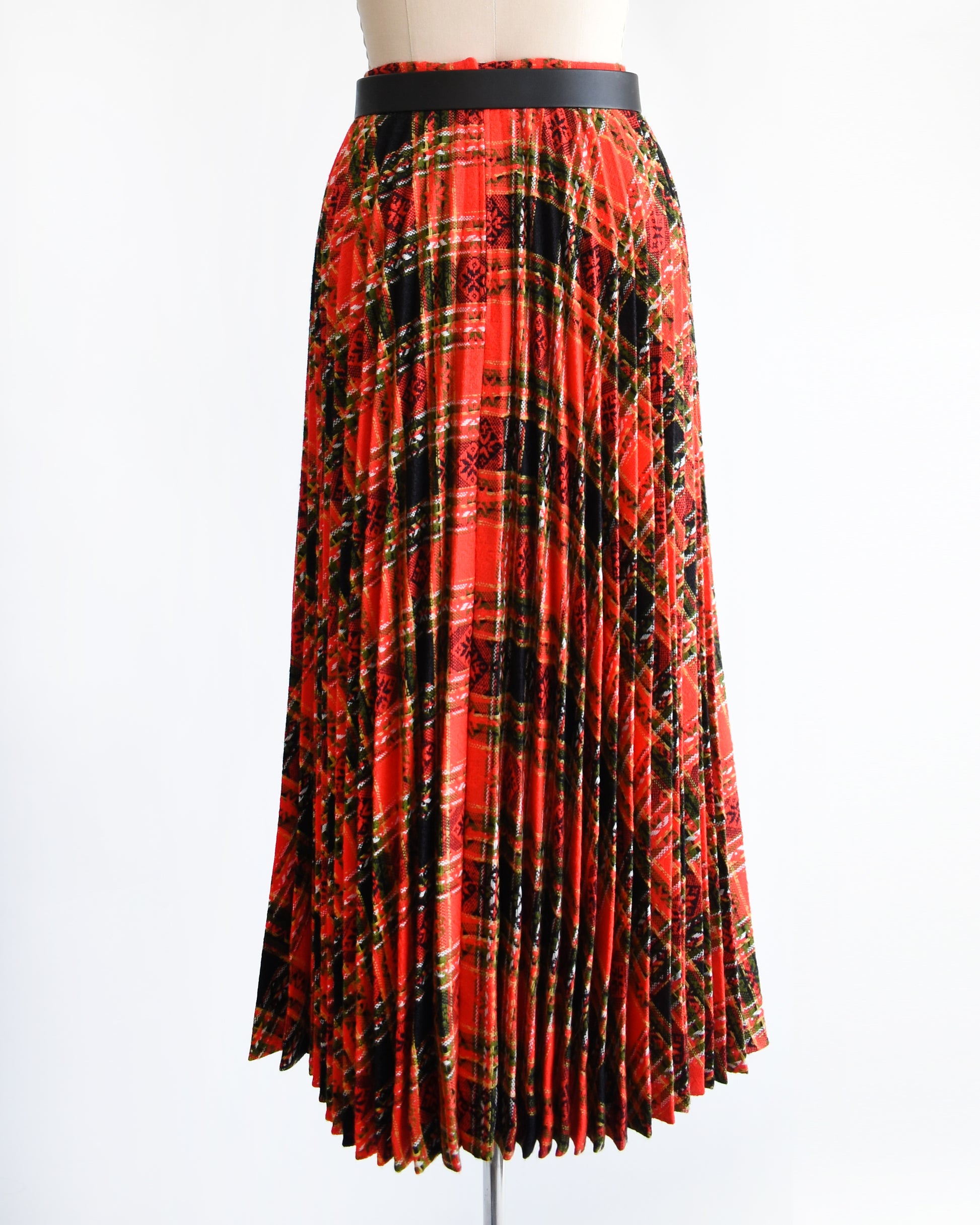 back view of a vintage 1970s red plaid skirt on a mannequin against a white background