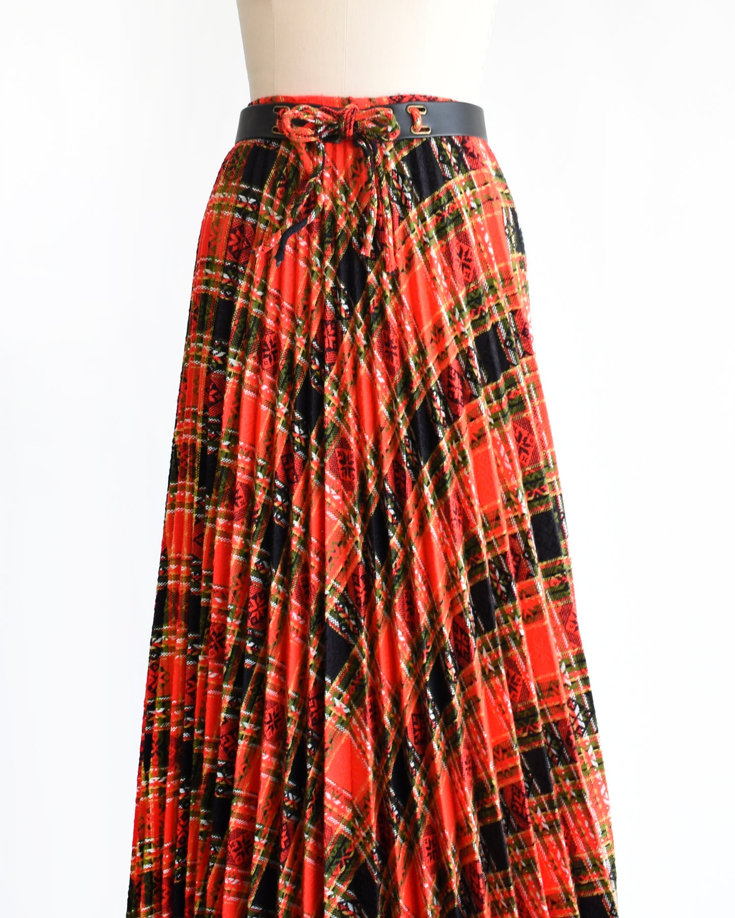 side front view of front view a vintage 1970s red plaid skirt on a mannequin against a white background. 