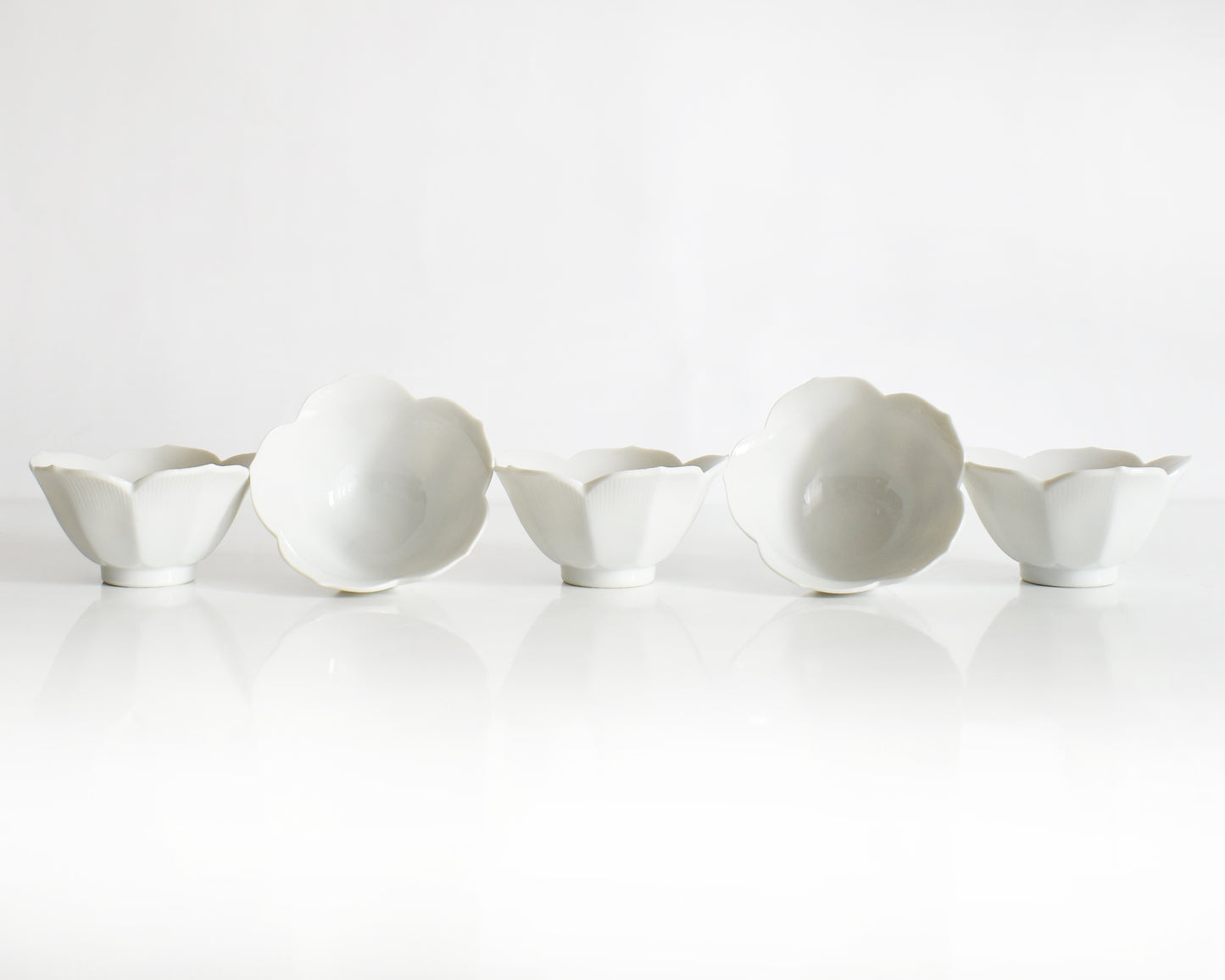 Set of white ceramic bowls on a white background
