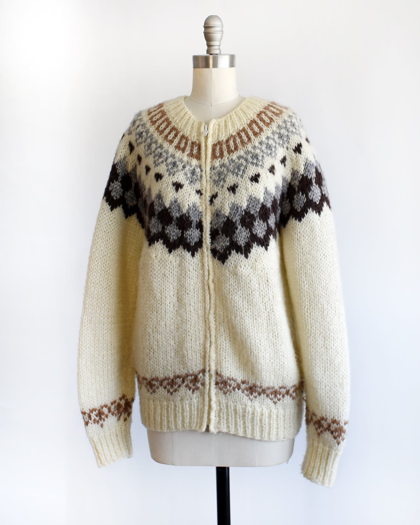 side front view of a vintage 1970s Fair Isle zip up sweater on a mannequin against a white background