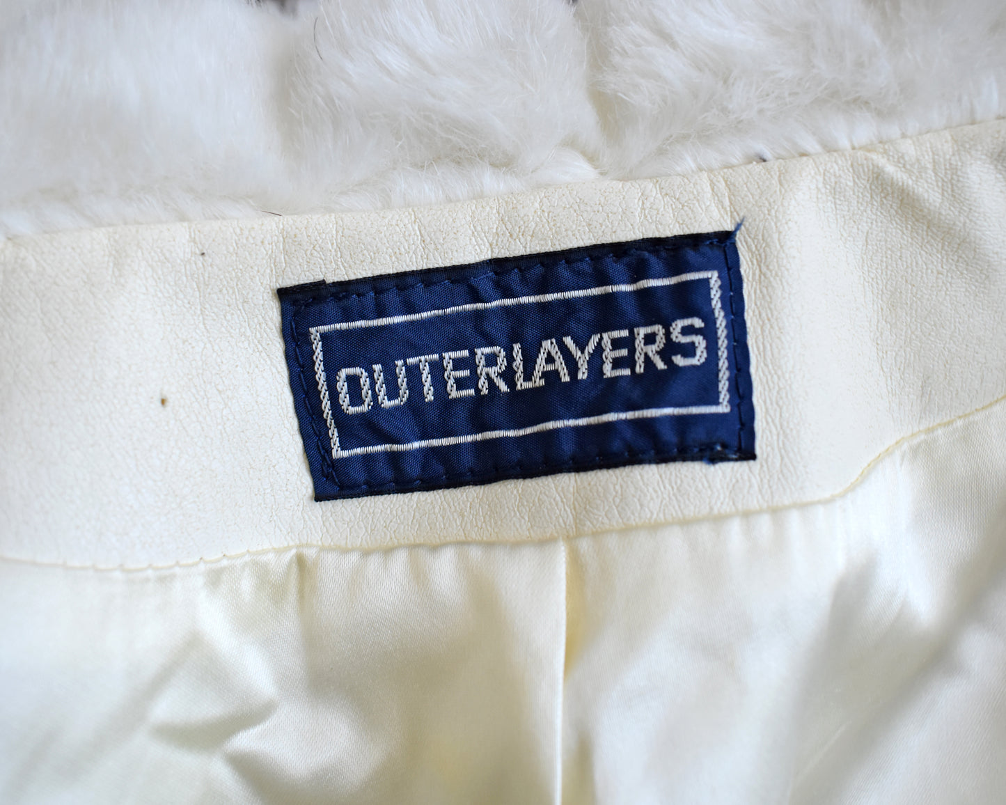 close up of the tag that says OUTERLAYERS