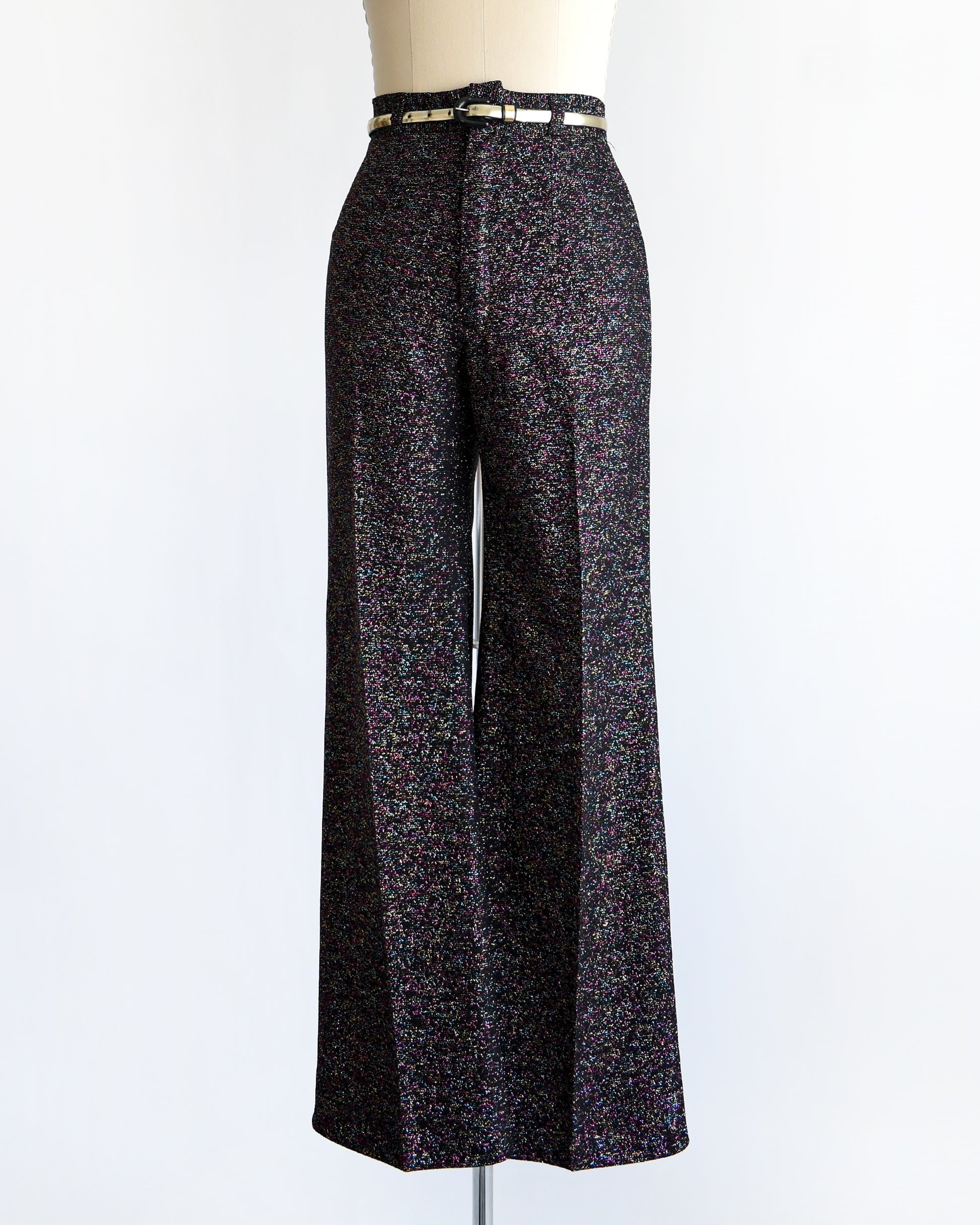 a pair of vintage 1970s black rainbow metallic pants with a silver belt on a mannequin against a white background