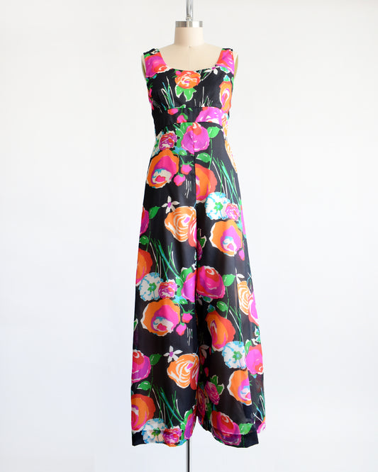 A vintage 1970s black floral print jumpsuit by Malia on a dress form