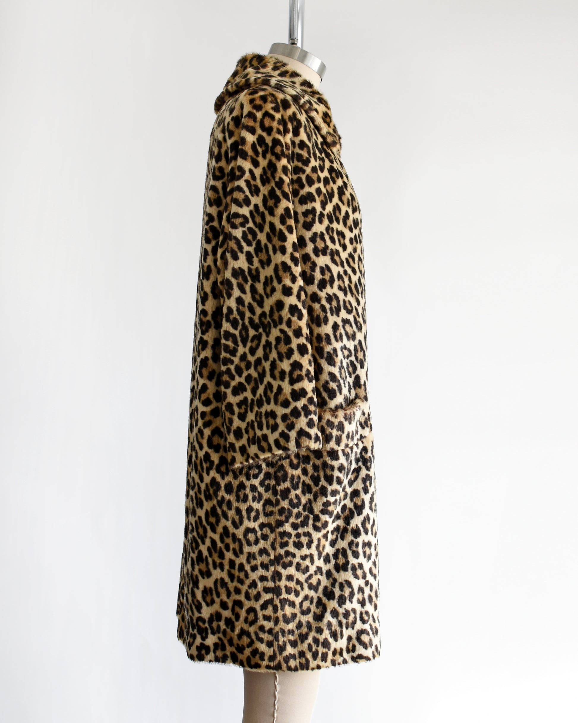 side view of a vintage 1960s faux fur leopard print coat on a dress form against a white background