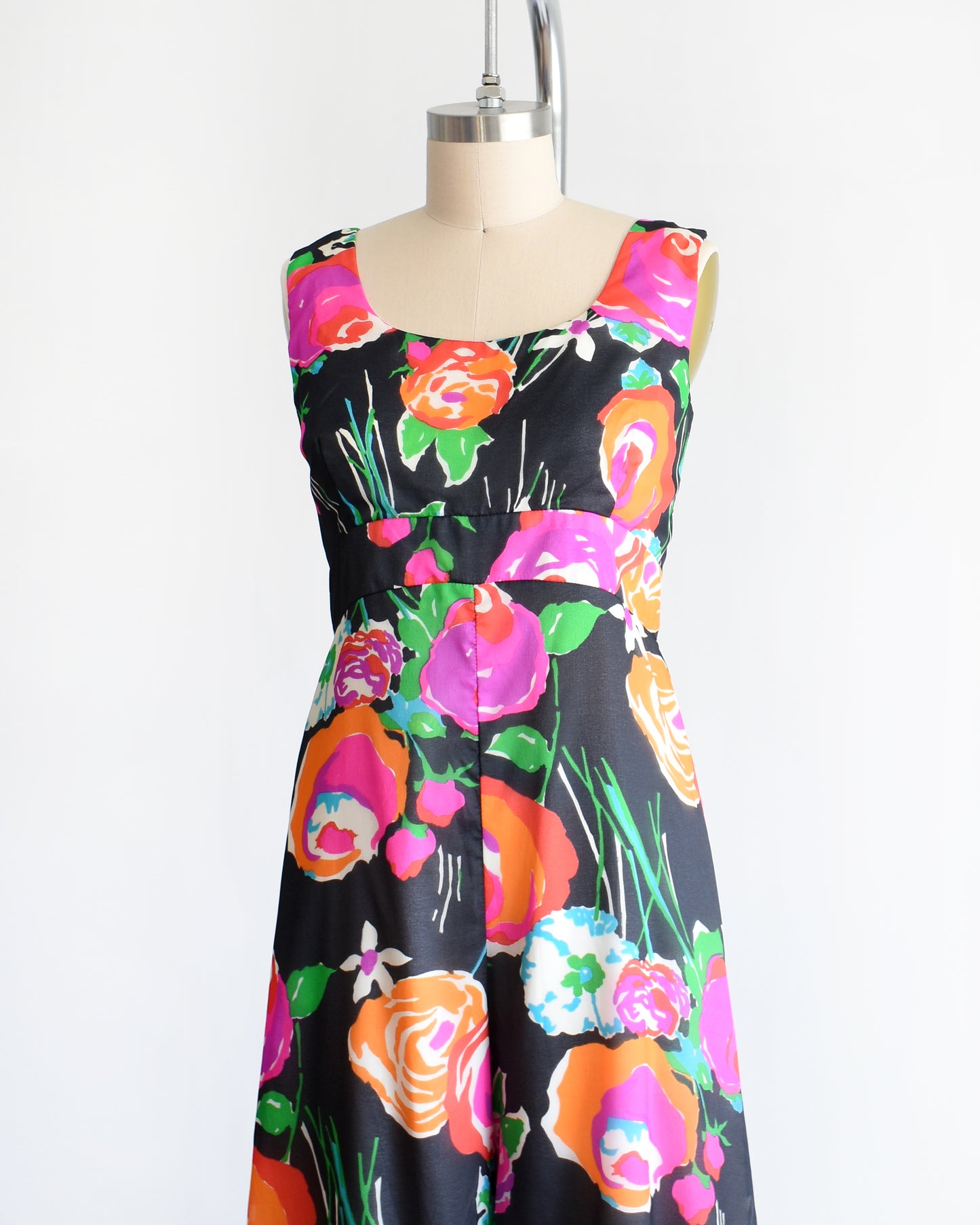 side front view of a vintage 1970s black floral print jumpsuit by Malia on a dress form