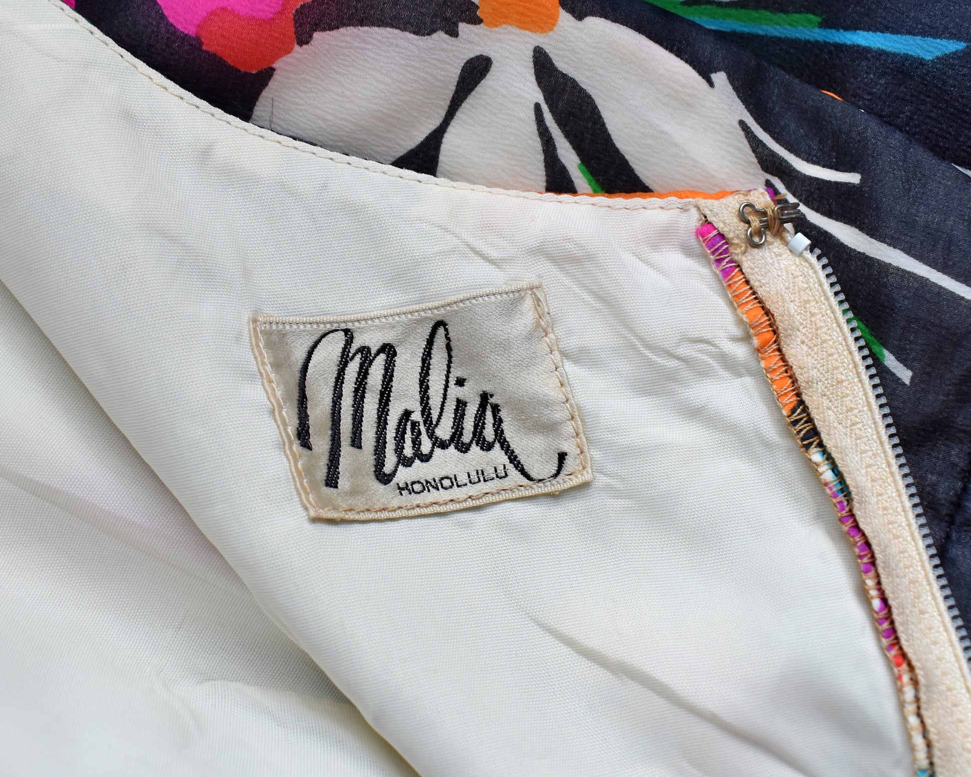 close up of the tag which says Malia Honolulu