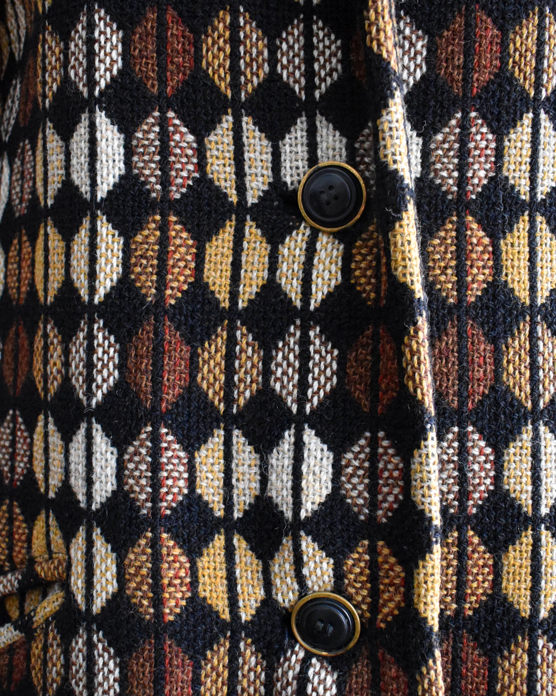 Close-up of a patterned fabric with buttons on a textured background