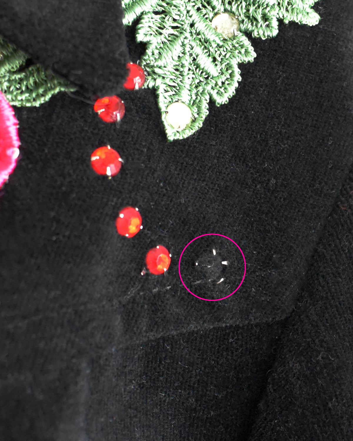 close up of the left shoulder which shows the missing rhinestone