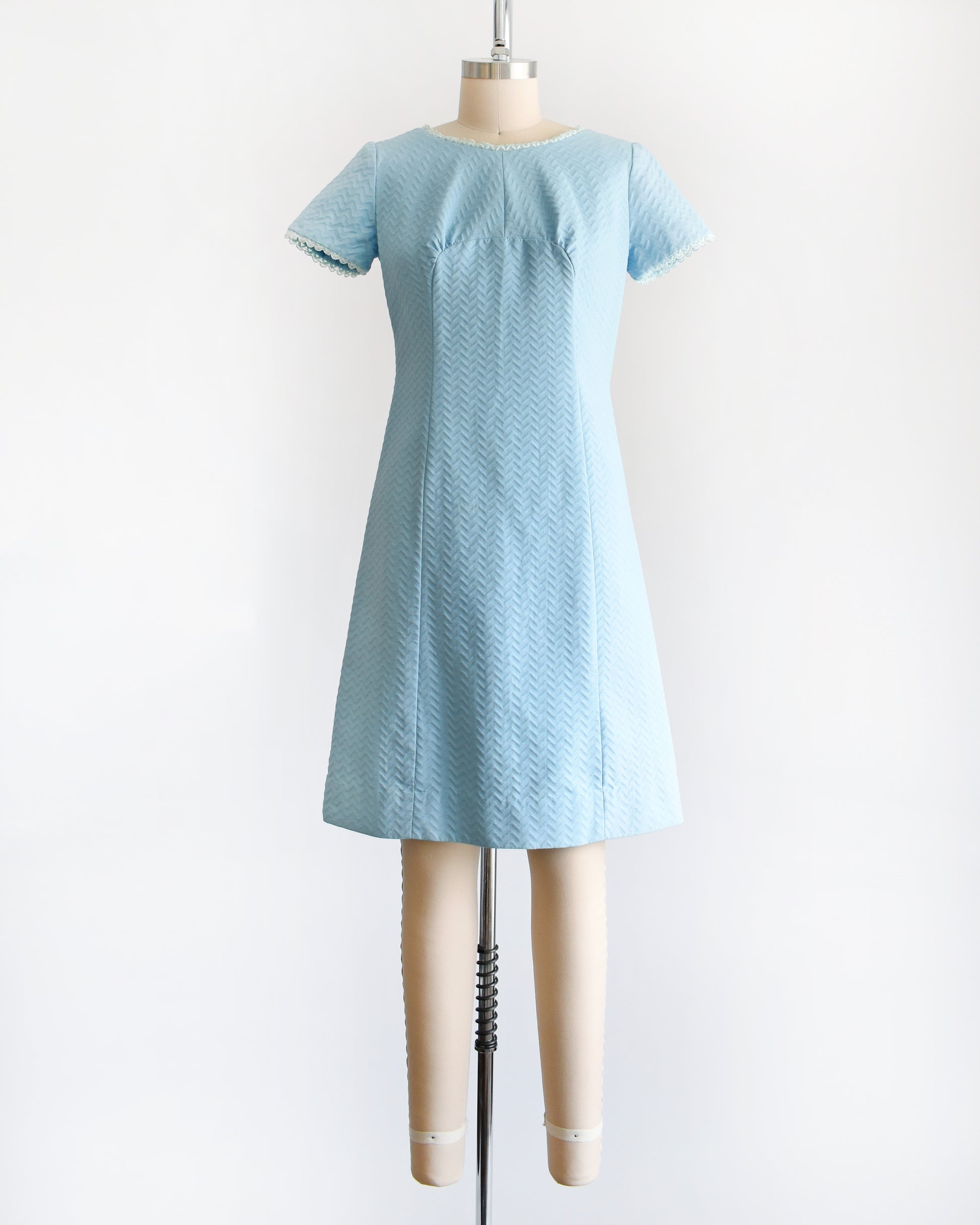 A vintage 1960s mod dress that has textured light blue chevron striped knit with alternating ribbing. 