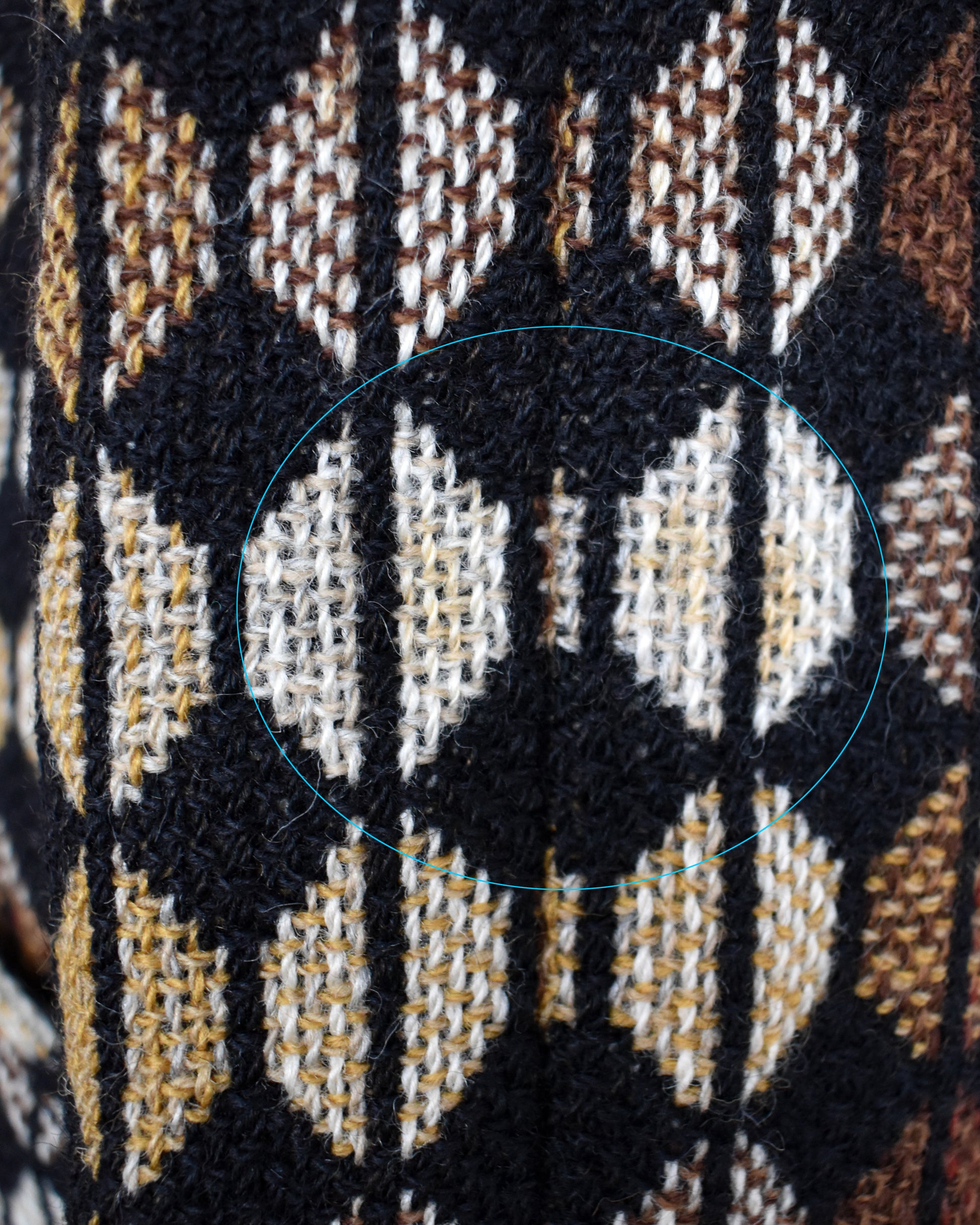 Close-up of  the sleeve which has a slight discolored spot which is circled