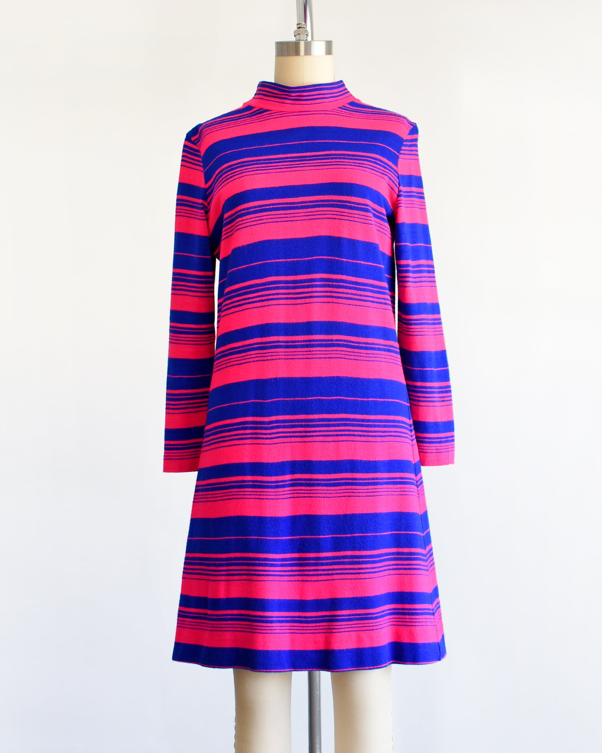 a vintage 1960s pink and blue horizontal mod dress on a dress form