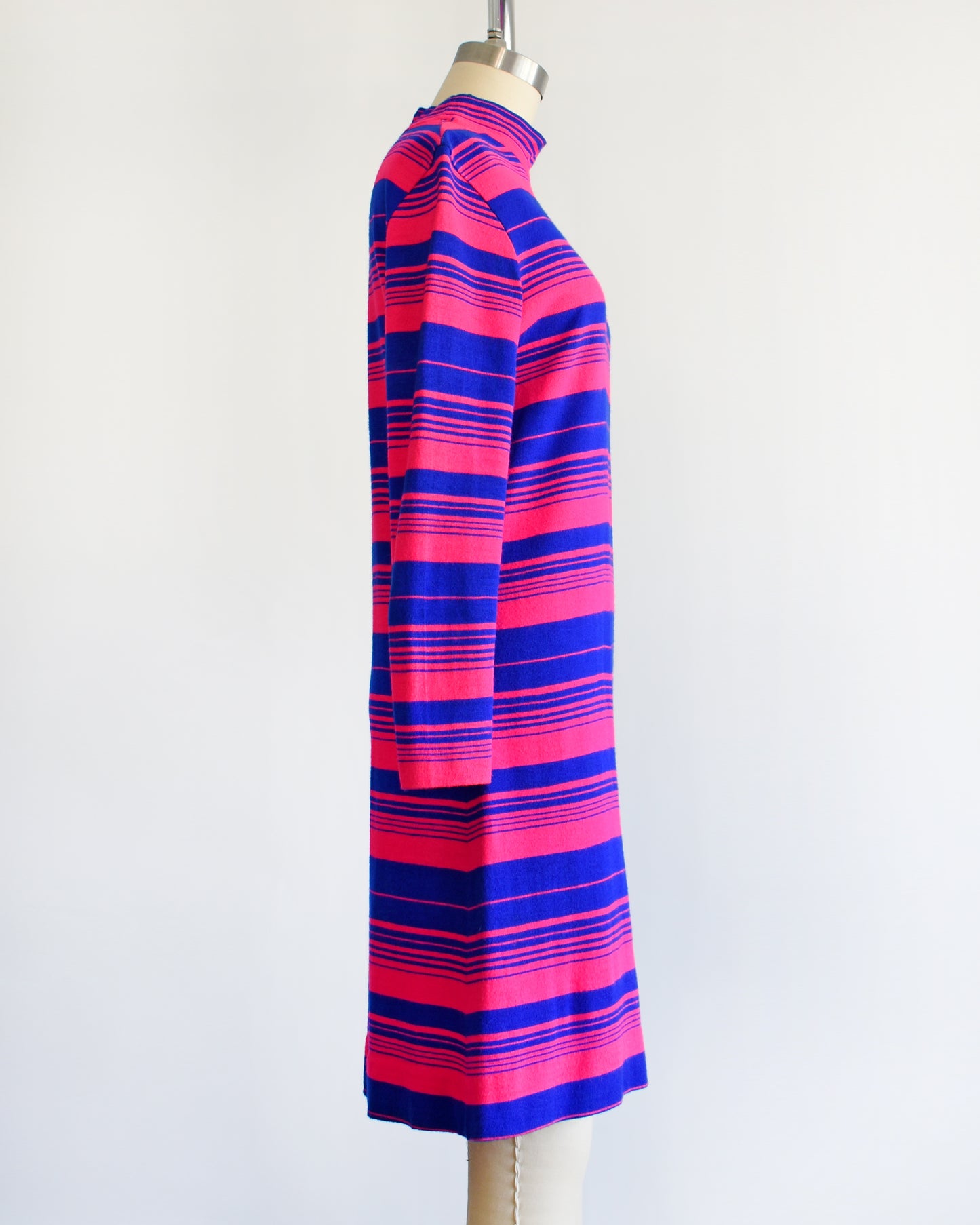 side view of a vintage 1960s pink and blue horizontal mod dress on a dress form