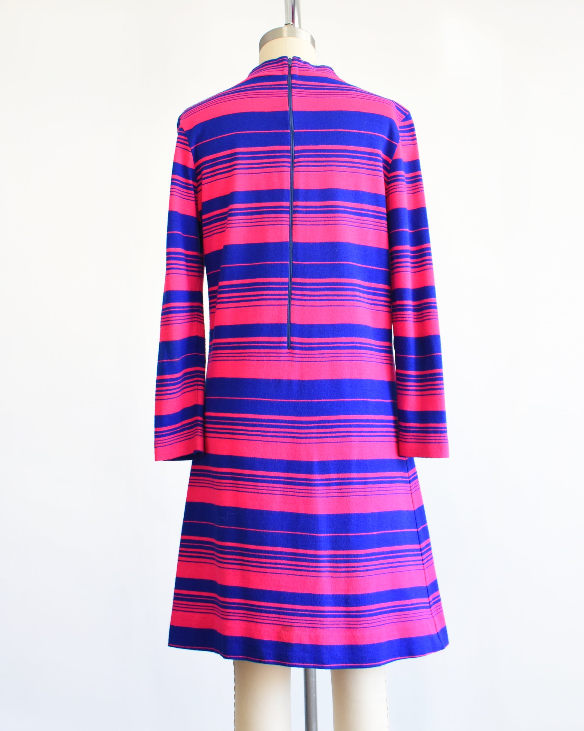 back view of a vintage 1960s pink and blue horizontal mod dress on a dress form