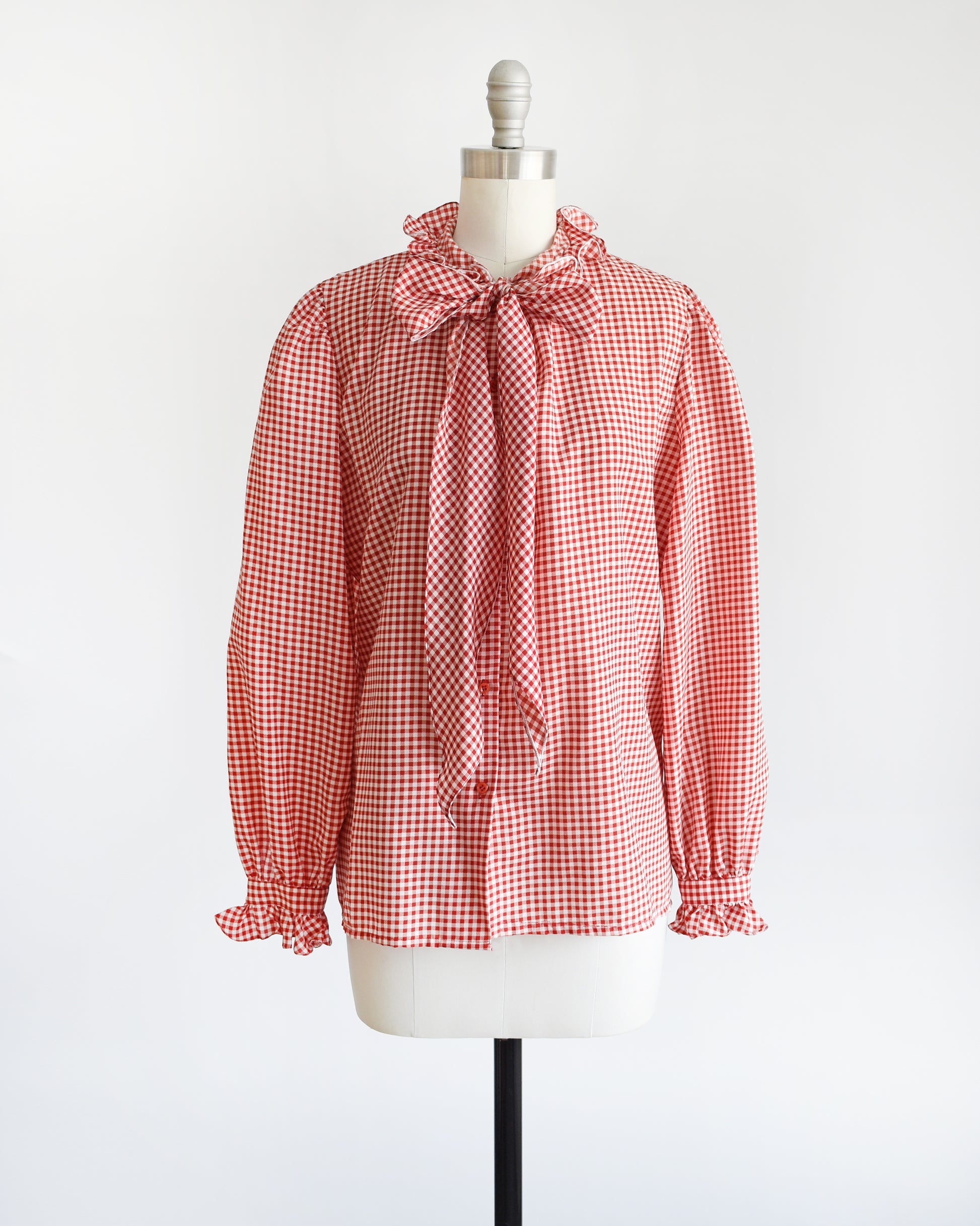 A A vintage 1980s red and white gingham blouse with ruffled collar and ascot bow