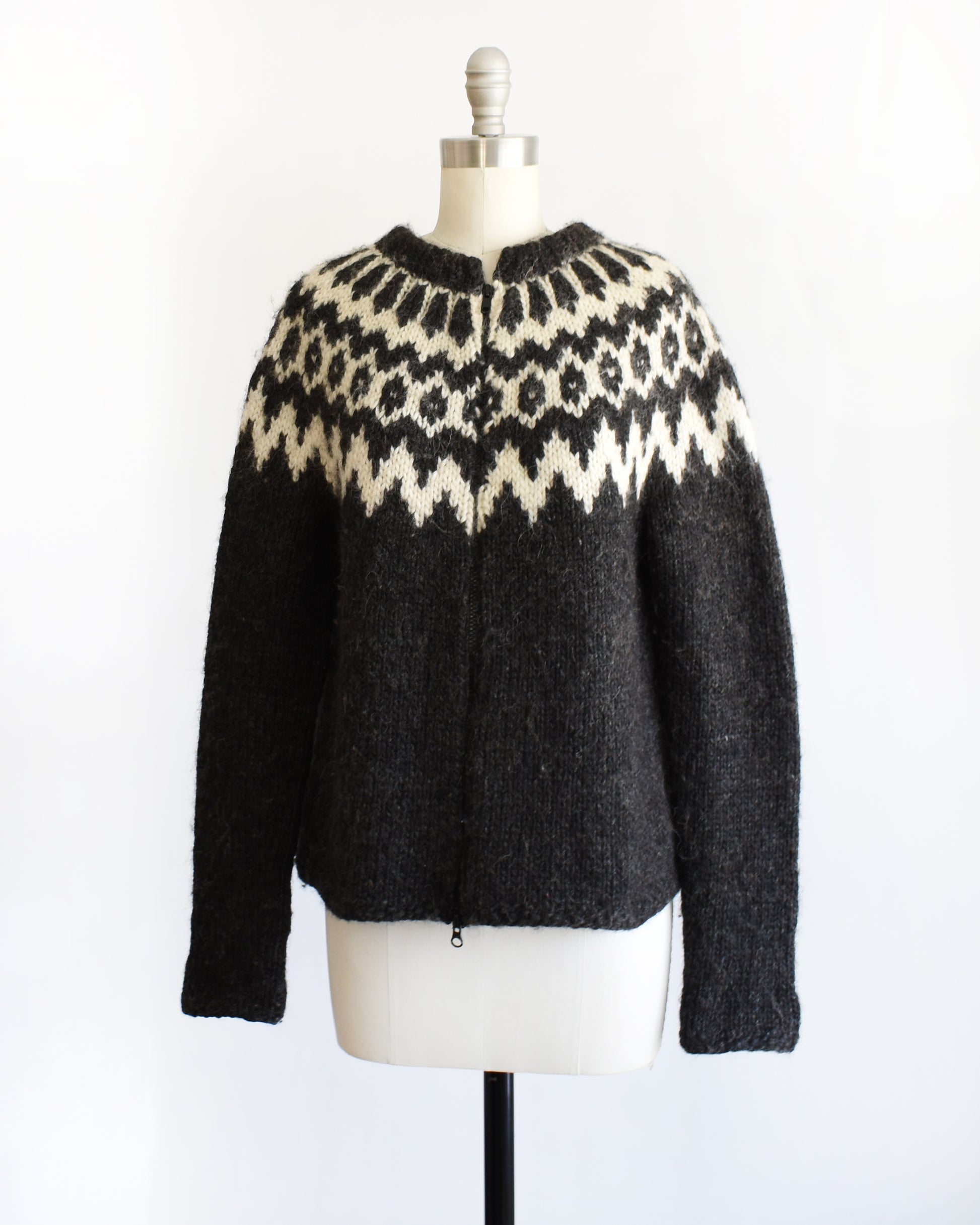 side front view of a vintage black and white Fair Isle patterned sweater on a mannequin against a white background