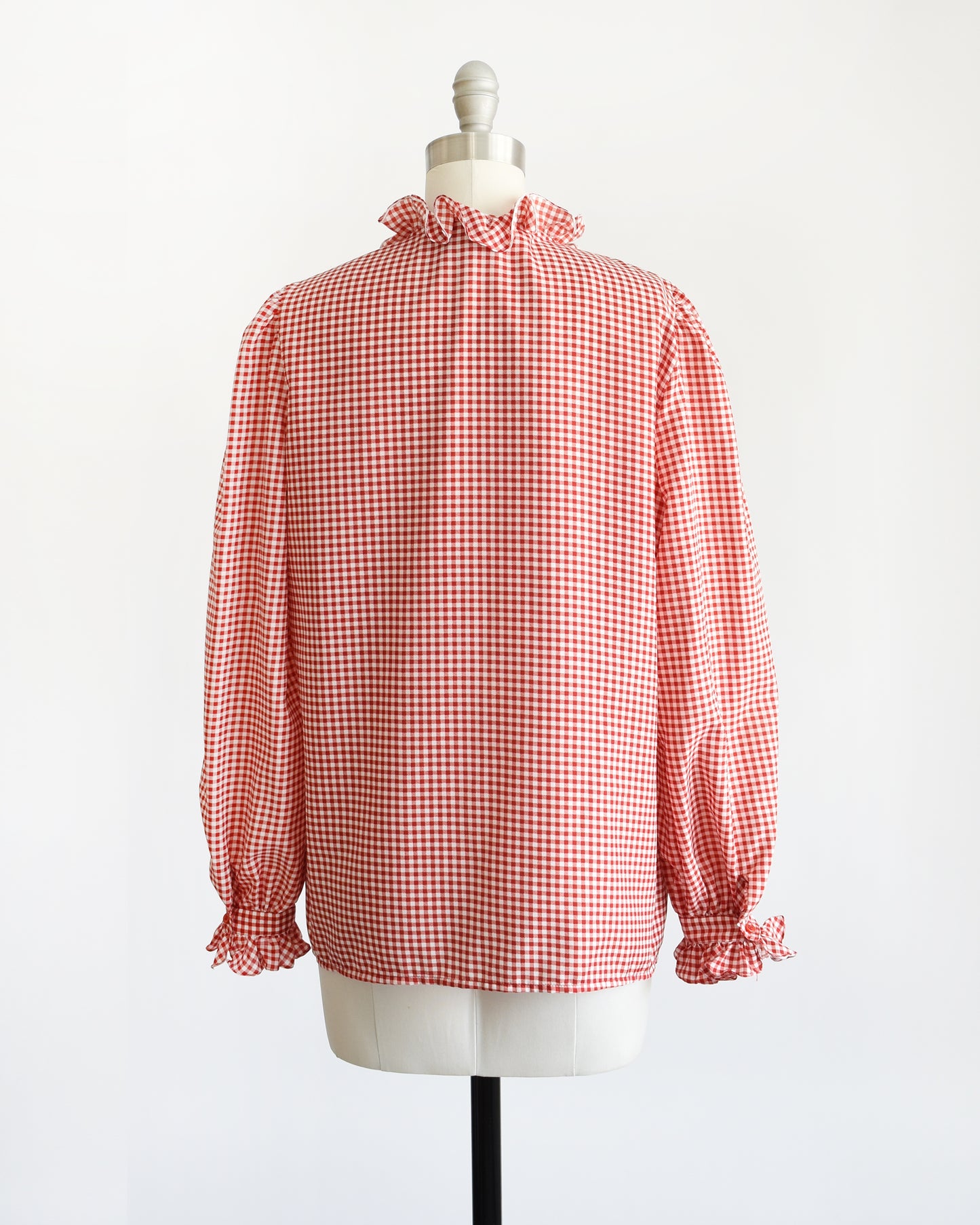 Back view of a vintage 1980s red and white gingham blouse with ruffled collar