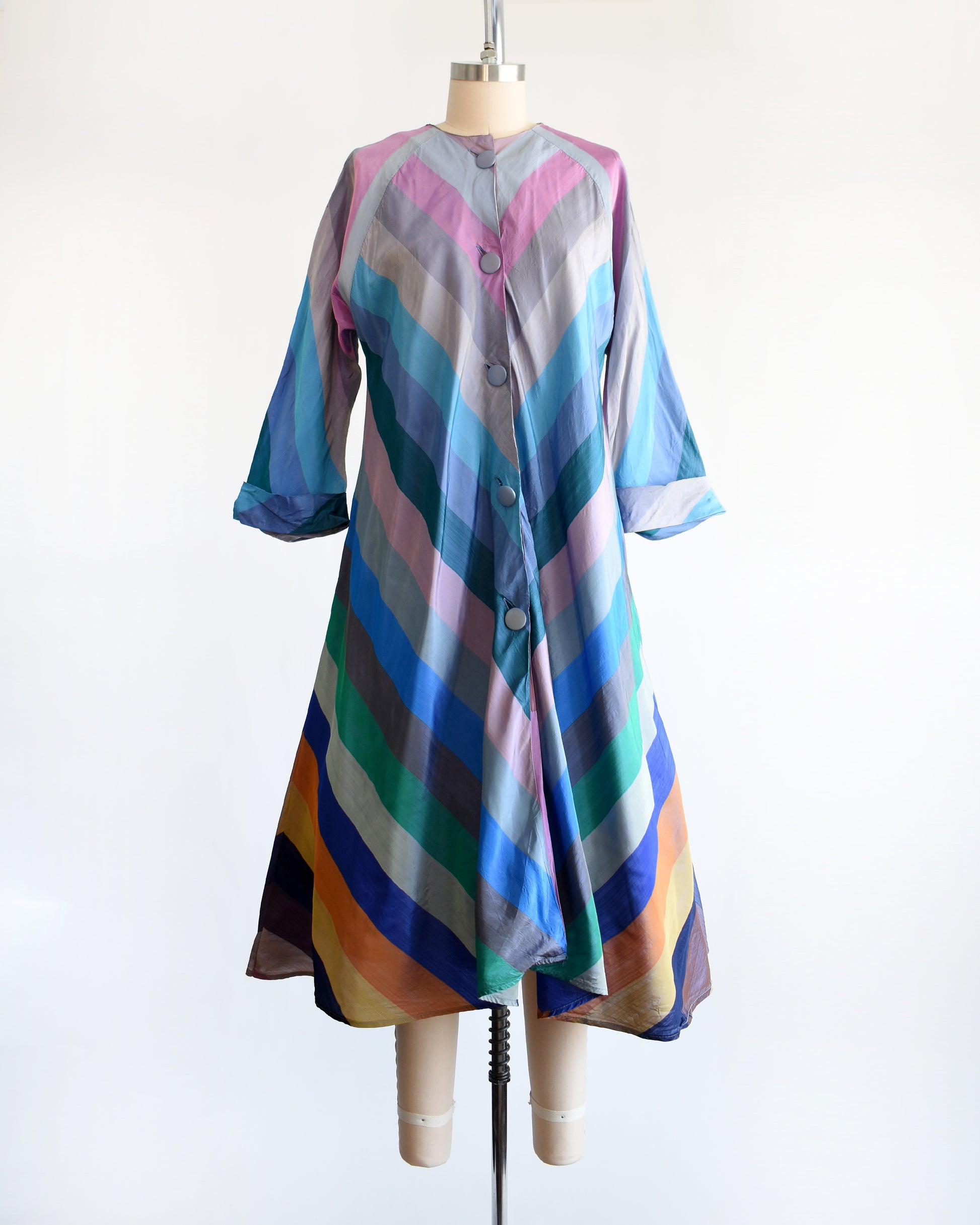 a vintage 1940s multicolored striped dress  robe on a mannequin against a white background