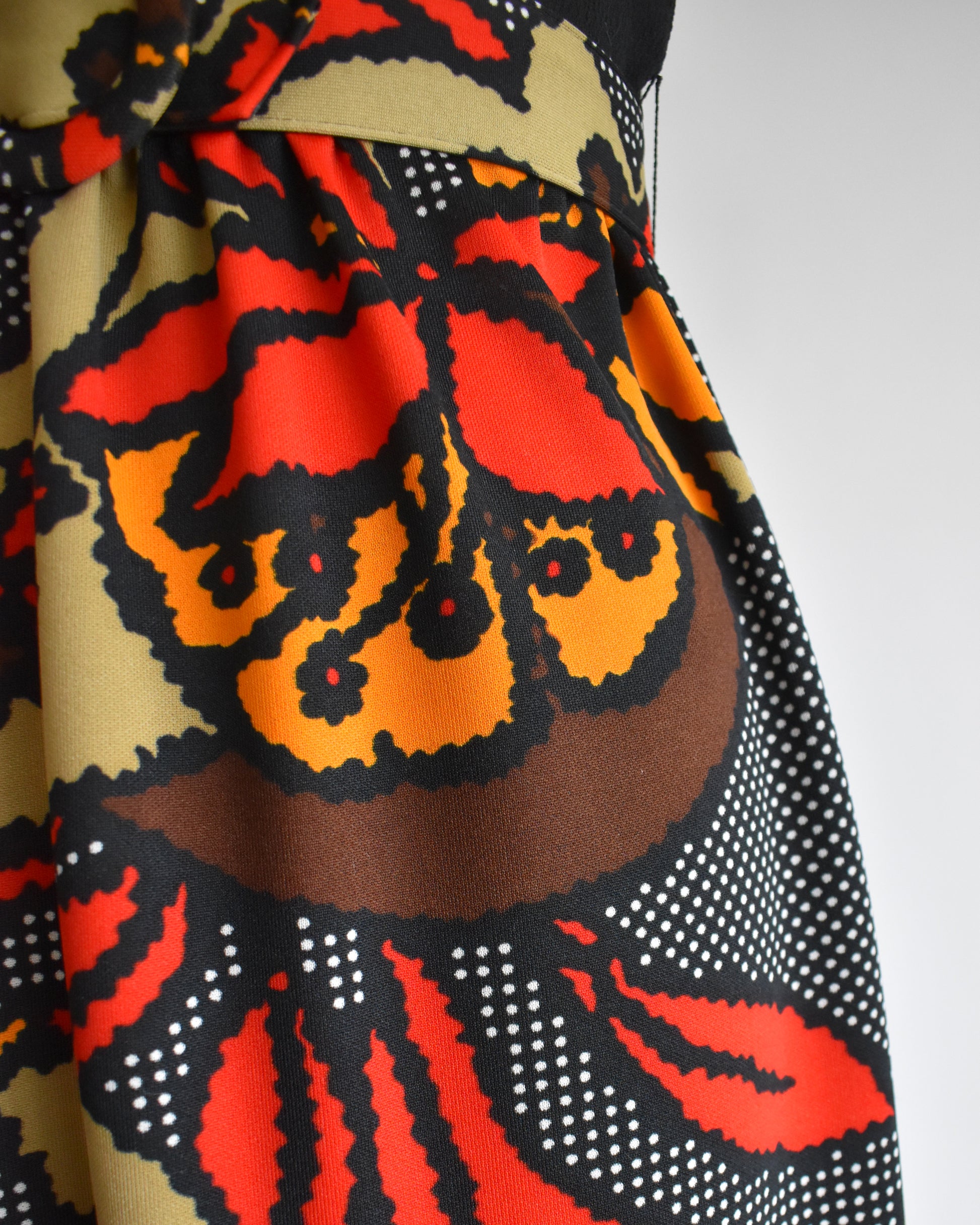 close up of the colorful bold floral print skirt with matching belt.