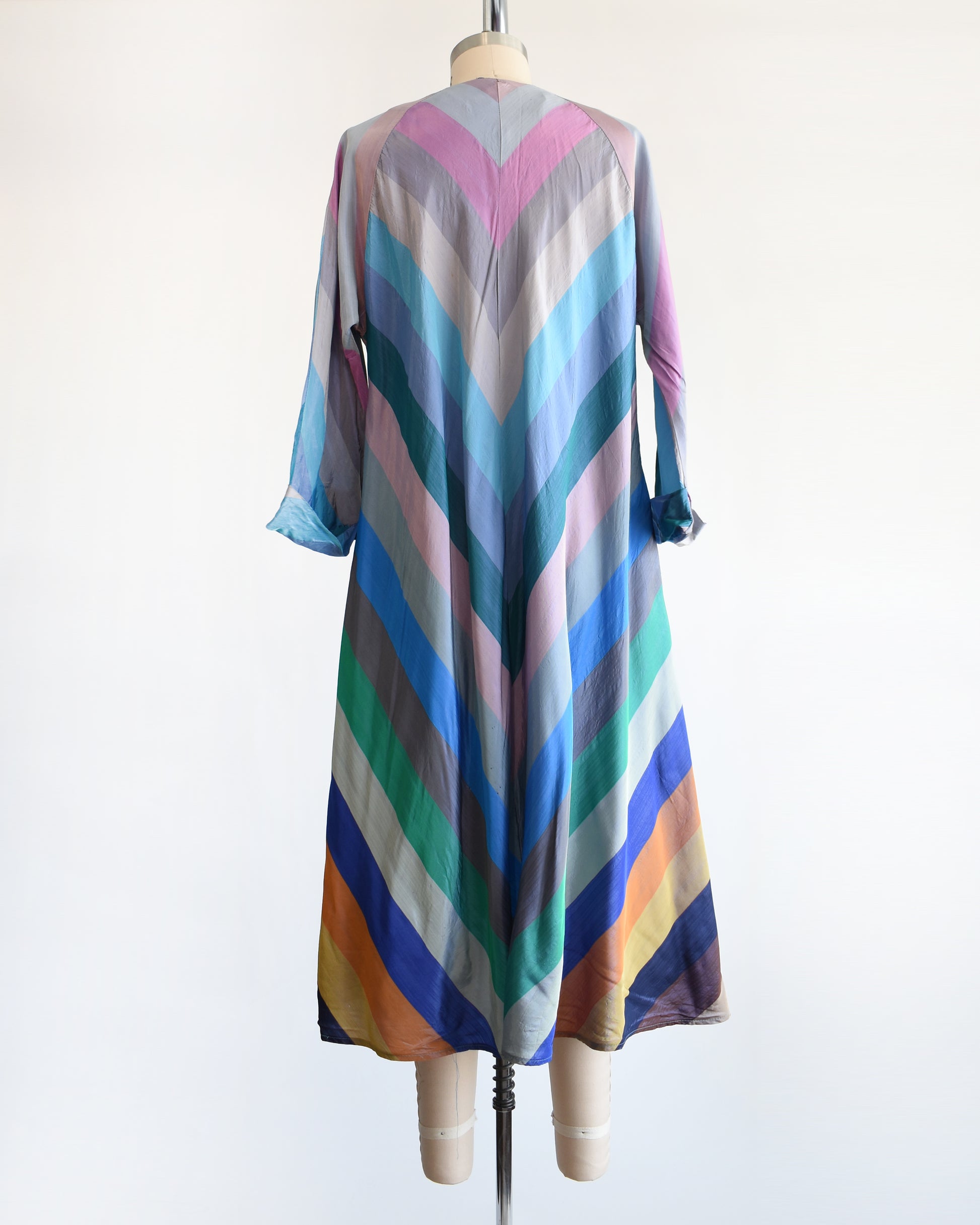 back view of a vintage 1940s multicolored striped dress  robe on a mannequin against a white background