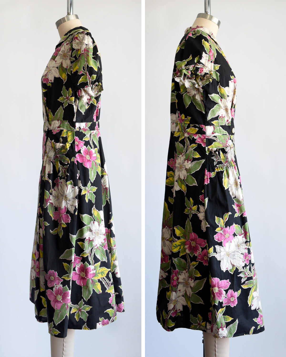 side by side side views of a vintage 1940s/1950s black midi dress with a vibrant pink, white, and green floral print, displayed on a cream mannequin against a plain white background.
